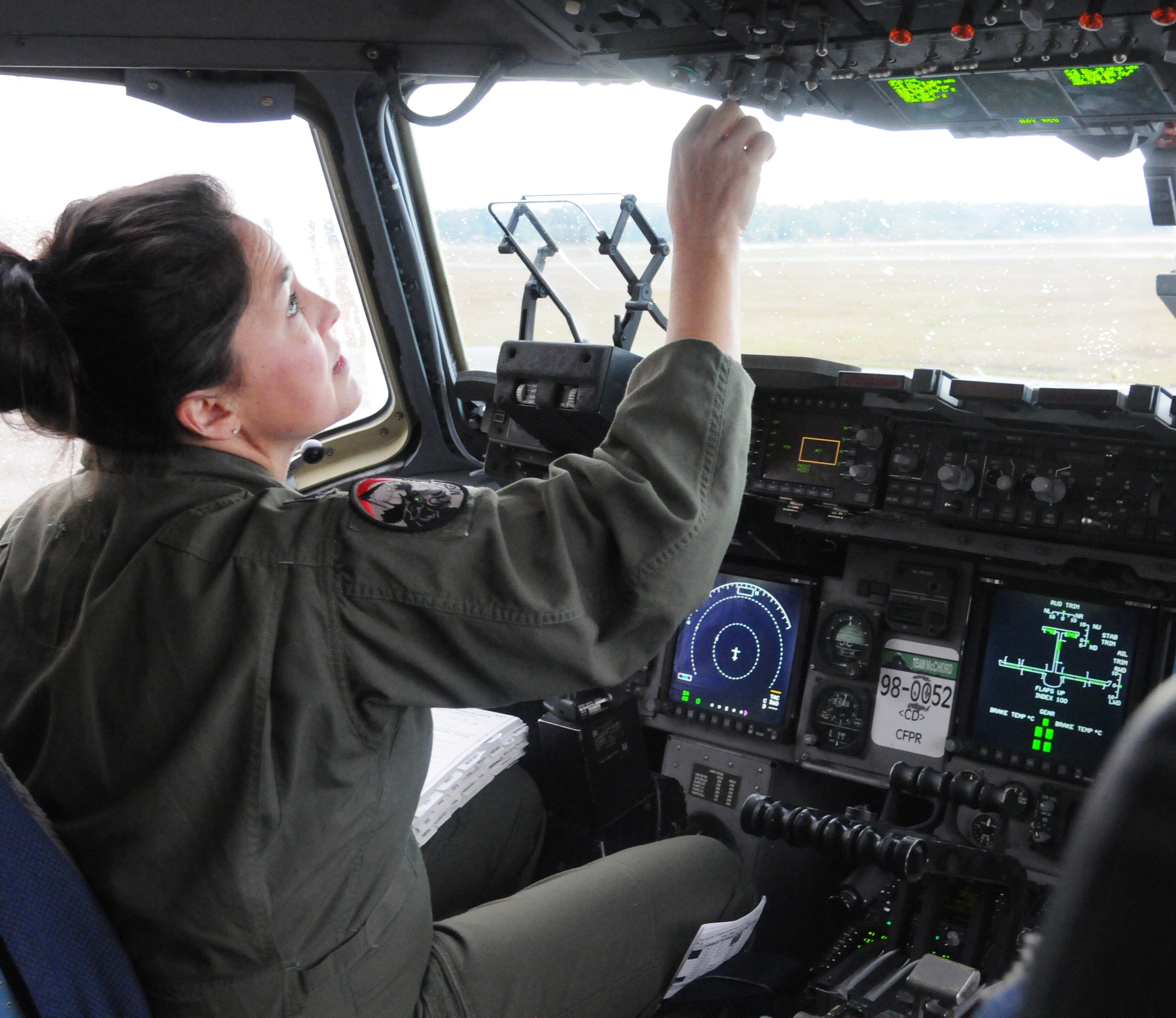 Lt. Col. Stephanie Severe, an Air Force Reserve pilot assigned to the 313th Airlift Squadron here, performs pre-flight checks before take off in a C-17 Globemaster III on March 15, 2021.