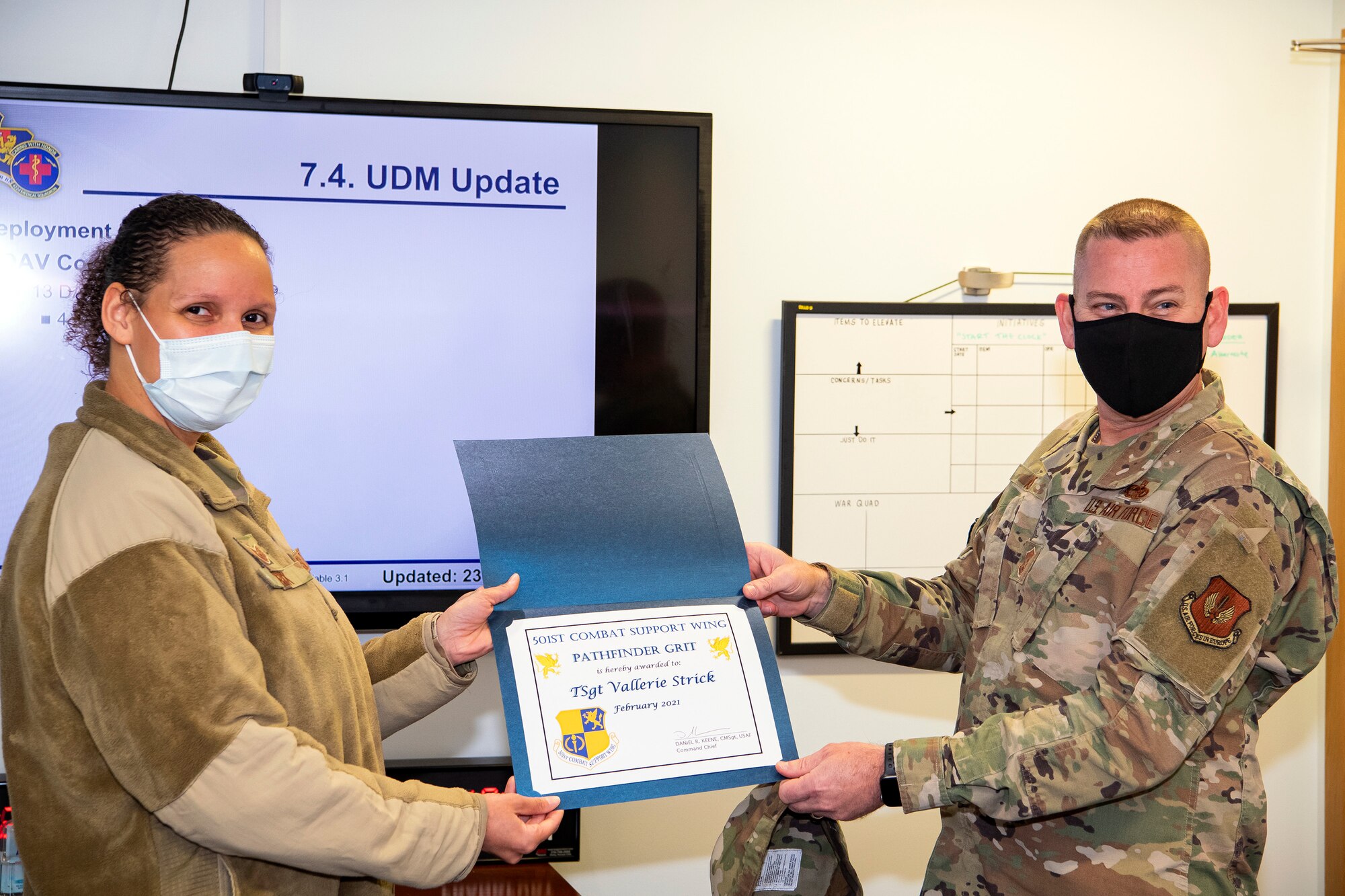 Chief Master Sgt. Daniel Keene, right, 501st Combat Support Wing command chief, poses for a photo with TSgt Vallerie Strick, 422d Medical Squadron superintendent, at RAF Croughton, England, Mar. 23, 2021. Strick received the Pathfinder GRIT award for her exceptional performance as the superintendent of the 422d MDS. Strick has been instrumental in the advertisement, scheduling and administration of over 500 COVID-19 vaccines during the month of February. (U.S. Air Force photo by Senior Airman Eugene Oliver)