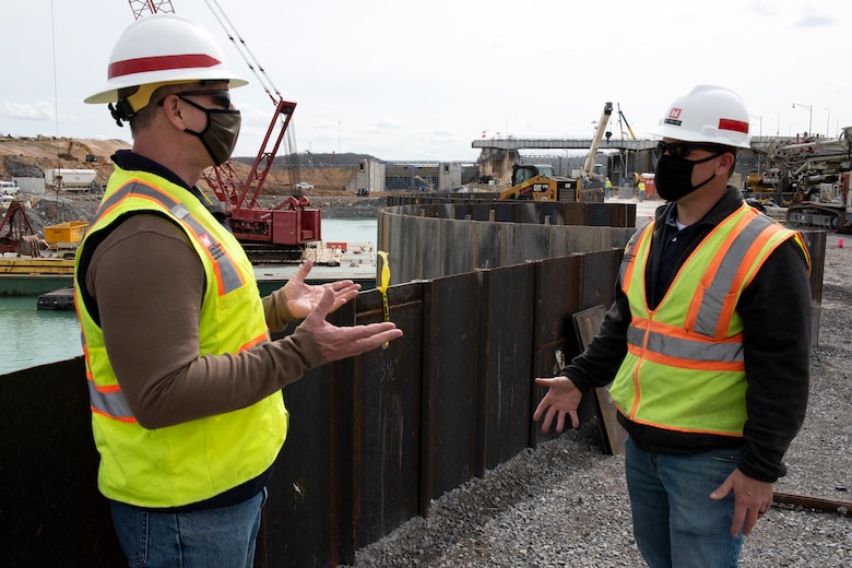 Barney Schulte (Left), lead engineer for the Kentucky Lock Addition Project, confers with Jody Robinson, Contract Team lead at Western Kentucky Area Office, while standing on top of the completed cofferdam at the Kentucky Lock Addition Project March 22, 2021 on the Tennessee River in Grand Rivers, Kentucky. The U.S. Army Corps of Engineers Nashville District is constructing a new 110-foot by 1,200-foot navigation lock at the Tennessee Valley Authority project. (USACE Photo by Lee Roberts)