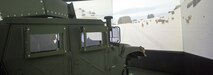 U.S. Marines assigned to Marine Wing Headquarters Squadron 2 navigate simulated obstacles in a combat convoy simulator at Camp Lejeune, N.C., Dec. 12, 2014.