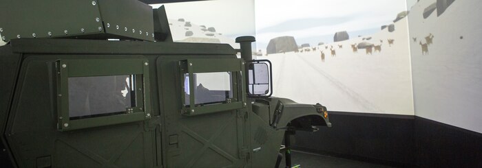 U.S. Marines assigned to Marine Wing Headquarters Squadron 2 navigate simulated obstacles in a combat convoy simulator at Camp Lejeune, N.C., Dec. 12, 2014.