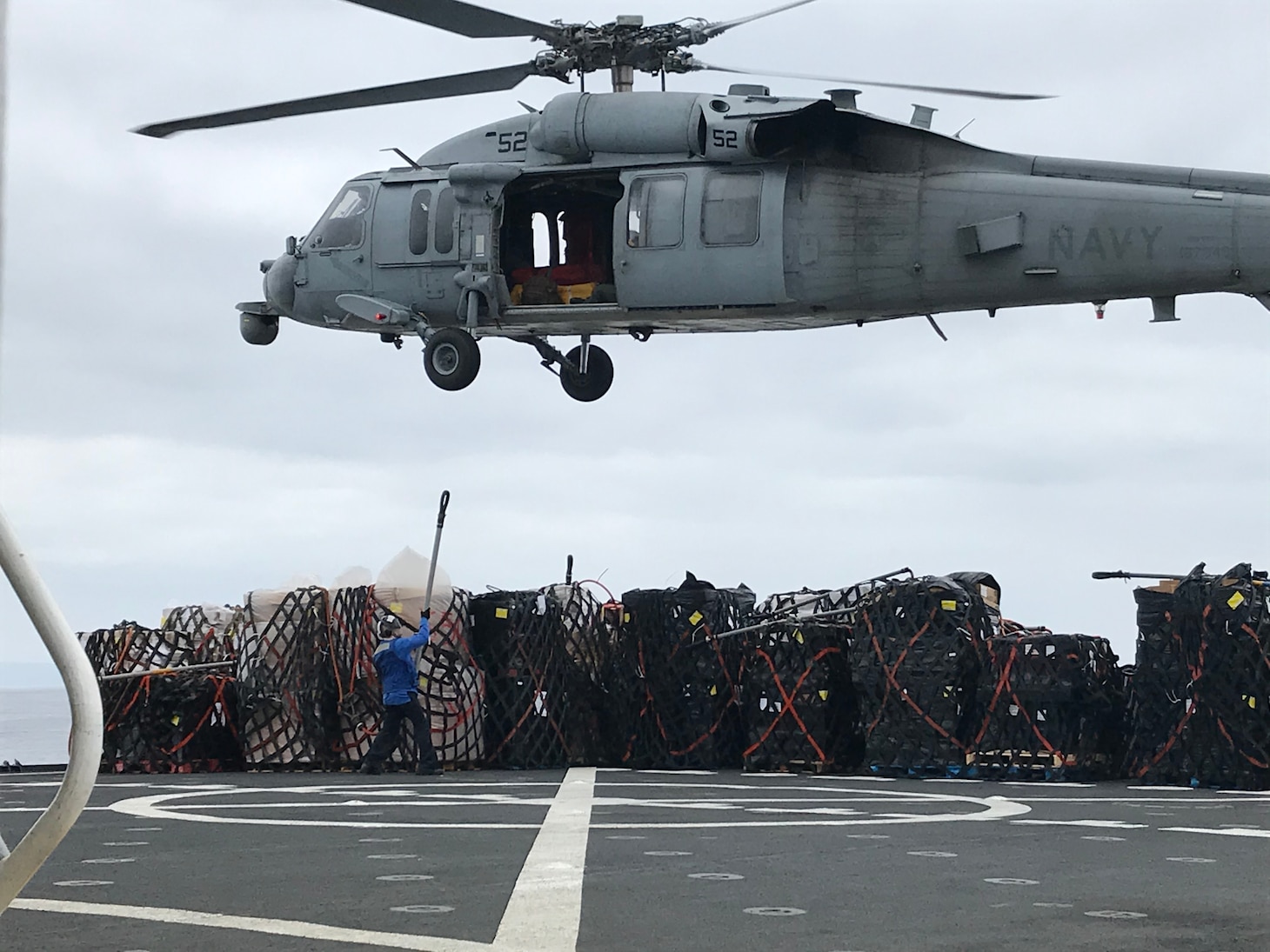 Military Sealift Command’s Navy Cargo Afloat Rig Team personnel providing support during vertical replenishment operations.
