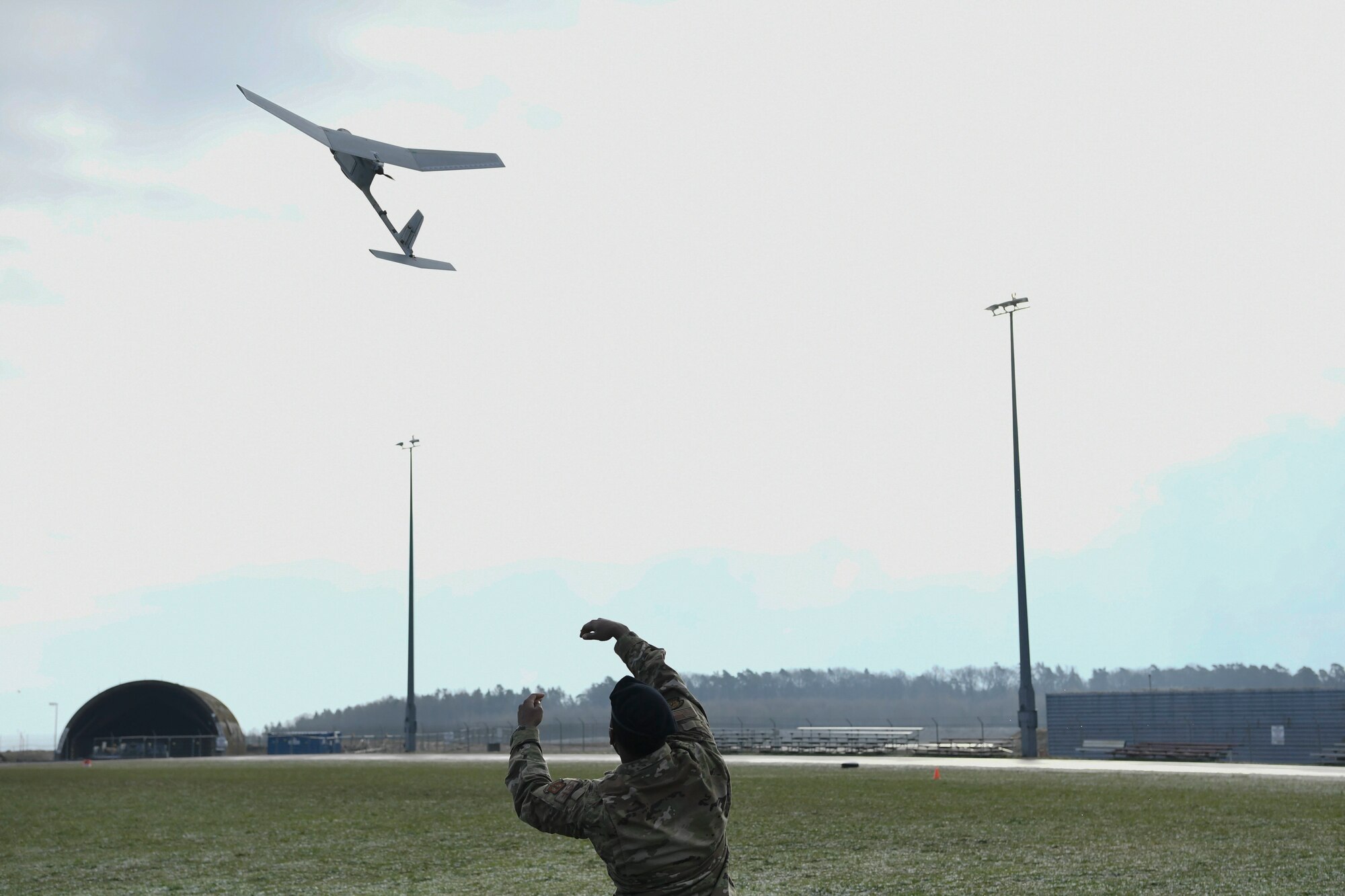 U.S. Air Force Staff Sergeant Donald Reid of the 52nd Fighter Wing Security Forces Squadron launches a Small Unmanned Aerial System, or sUAS, at Spangdahlem Air Base, Germany, March 19, 2021.