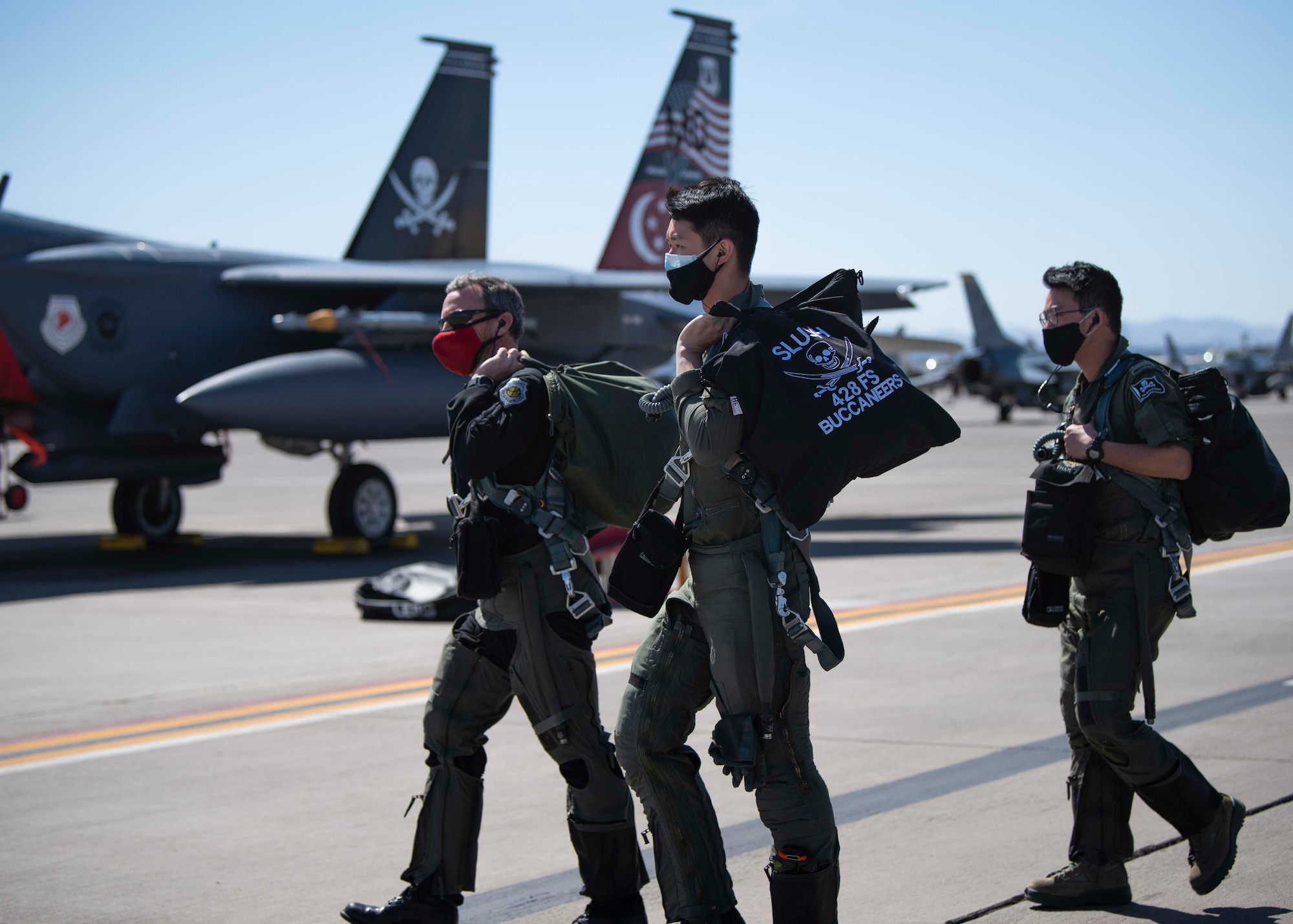 Republic of Singapore Air Force pilots walk down the flightline