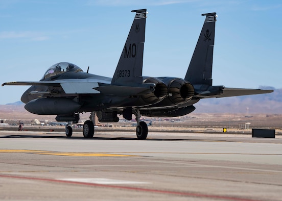 A fighter jet taxis down the flightline