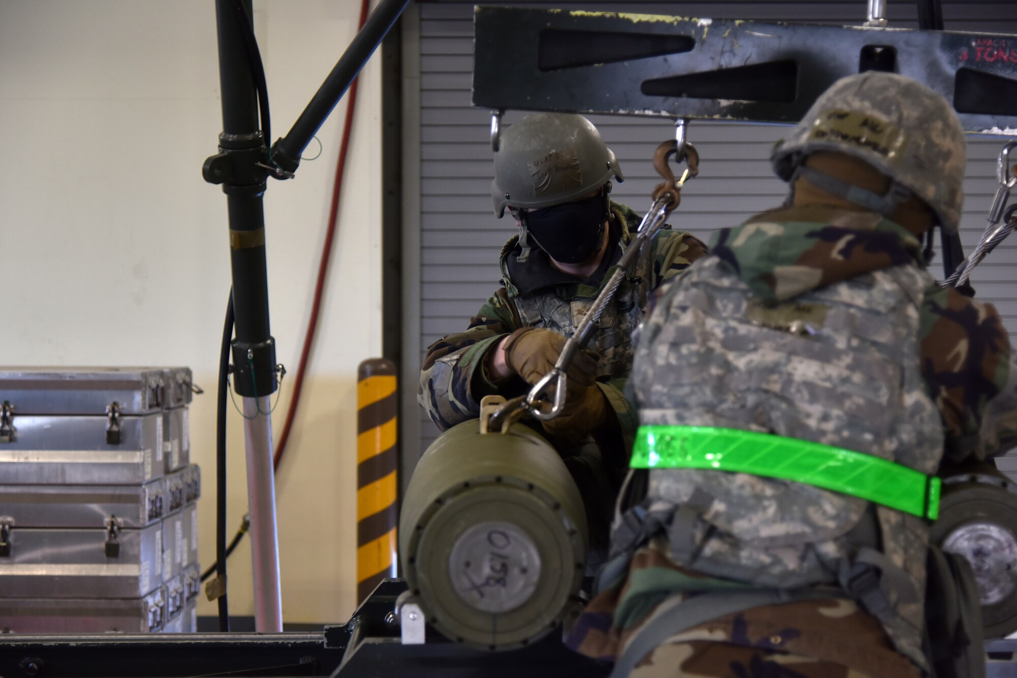 Eighth Maintenance Squadron conventional maintenance crew members load munitions onto a conveyor assembly line during a routine training event at Kunsan Air Base, Republic of Korea, March 24, 2021. The 8th MXS “Dragons” build and maintain munitions for the 8th Fighter Wing. (U.S. Air Force photo by Senior Airman Suzie Plotnikov)