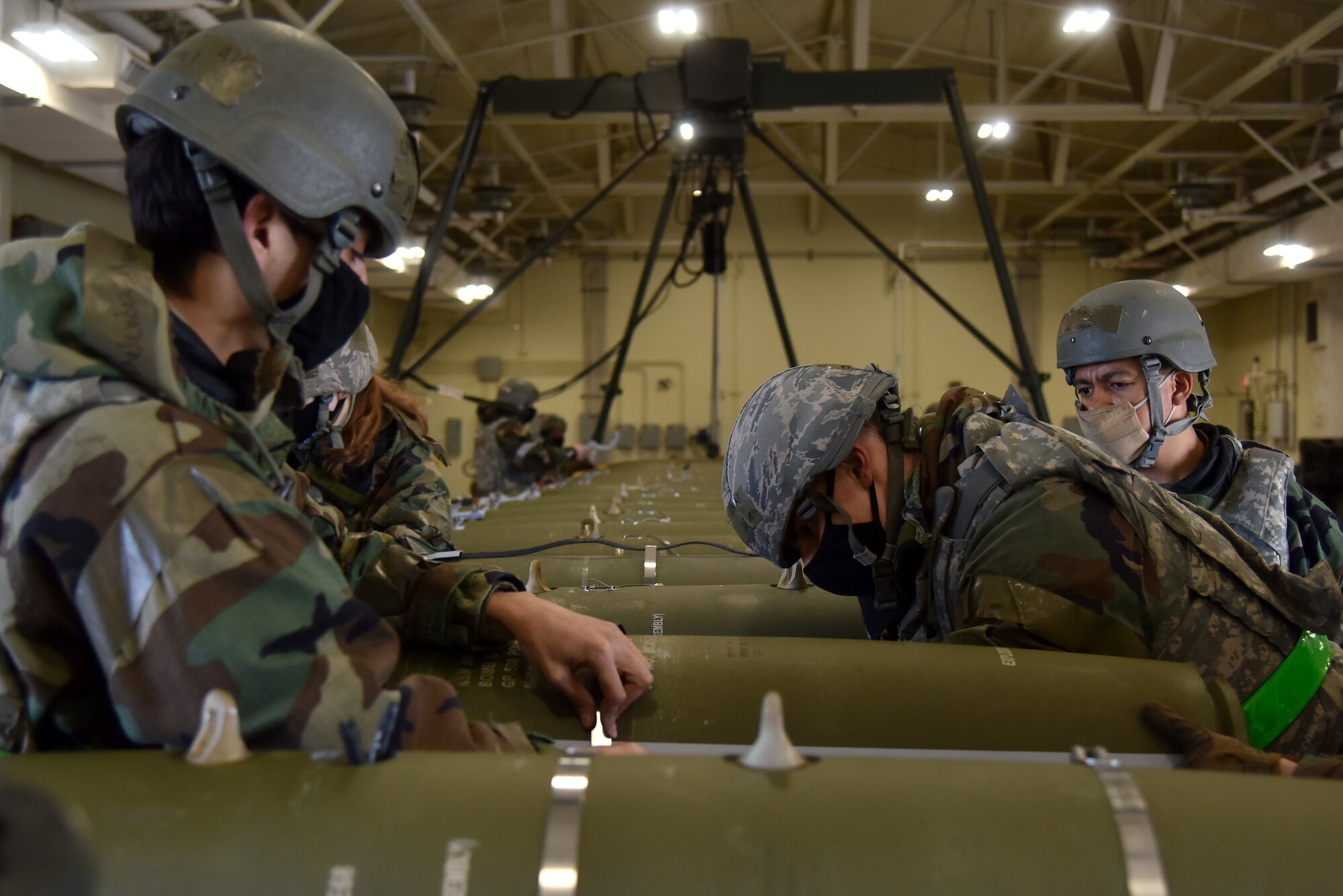 Eighth Maintenance Squadron Airmen tighten the umbilical cover straps on munitions during a routine training event at Kunsan Air Base, Republic of Korea, March 24, 2021. The 8th MXS “Dragons” build and maintain munitions for the 8th Fighter Wing. (U.S. Air Force photo by Senior Airman Suzie Plotnikov)