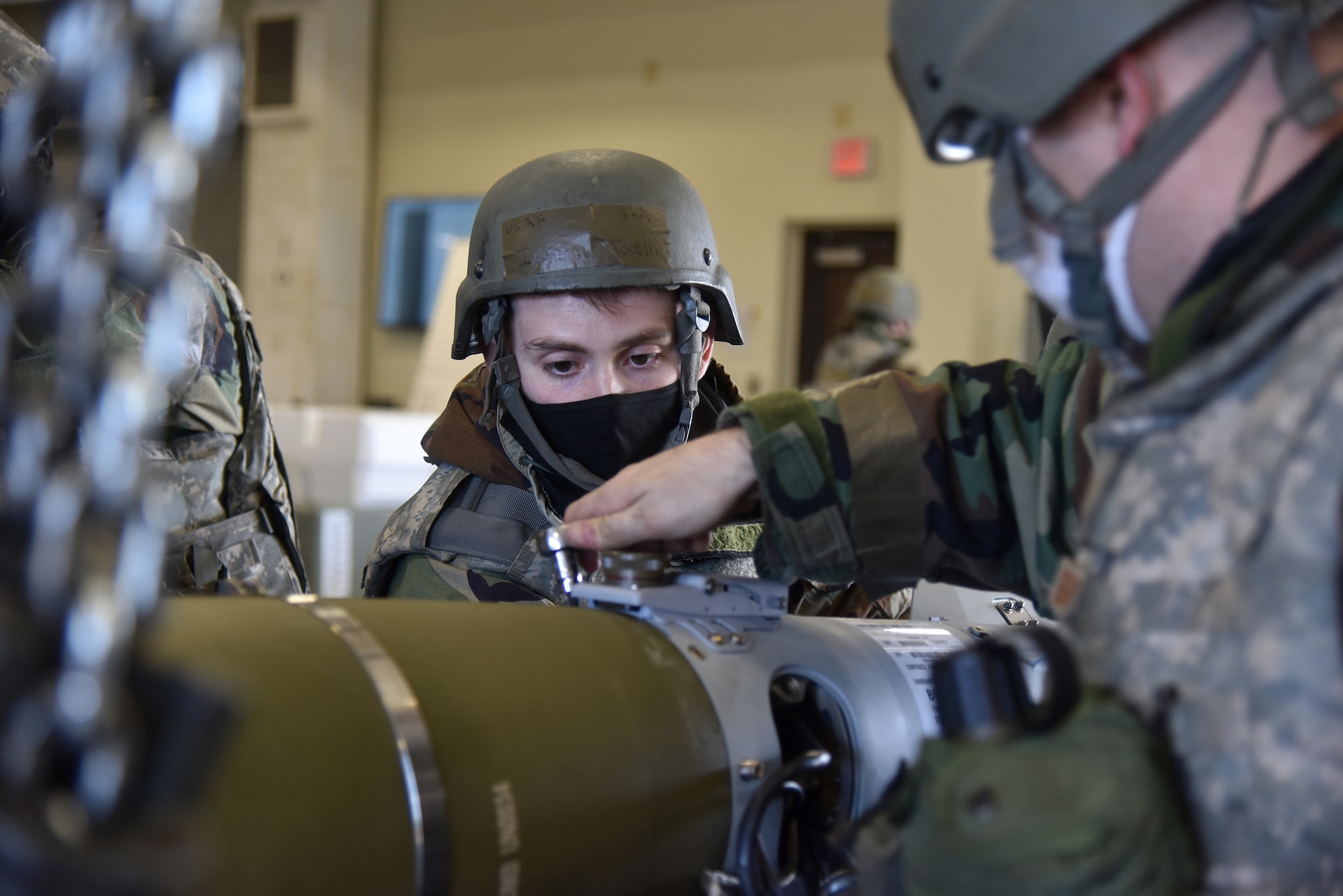Senior Airman Ismael Torelli, 8th Maintenance Squadron egress technician, attaches a tail kit on a munition during a routine training event at Kunsan Air Base, Republic of Korea, March 24, 2021. The 8th MXS “Dragons” build and maintain munitions for the 8th Fighter Wing.  (U.S. Air Force photo by Senior Airman Suzie Plotnikov)