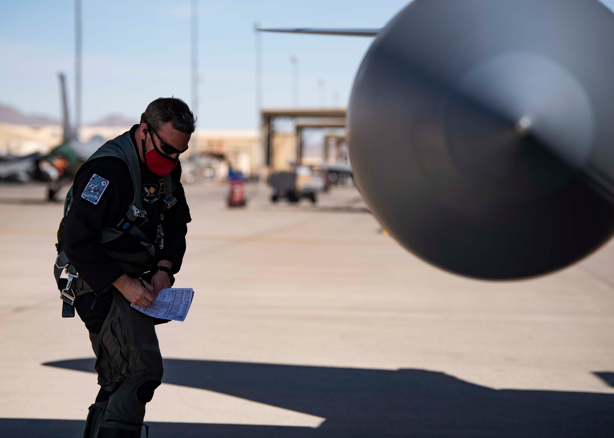 A pilot does a pre-flight inspection on a jet