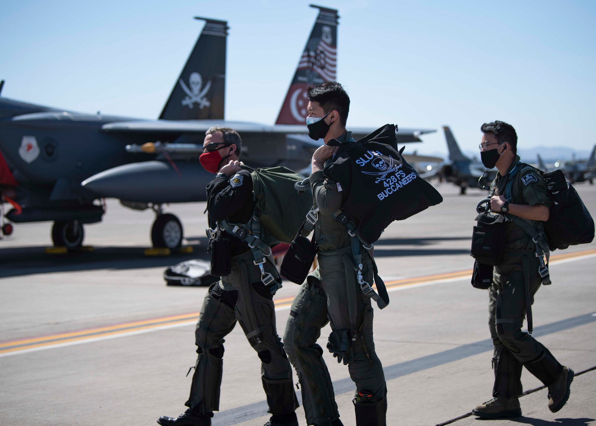 Republic of Singapore Air Force pilots walk down the flightline