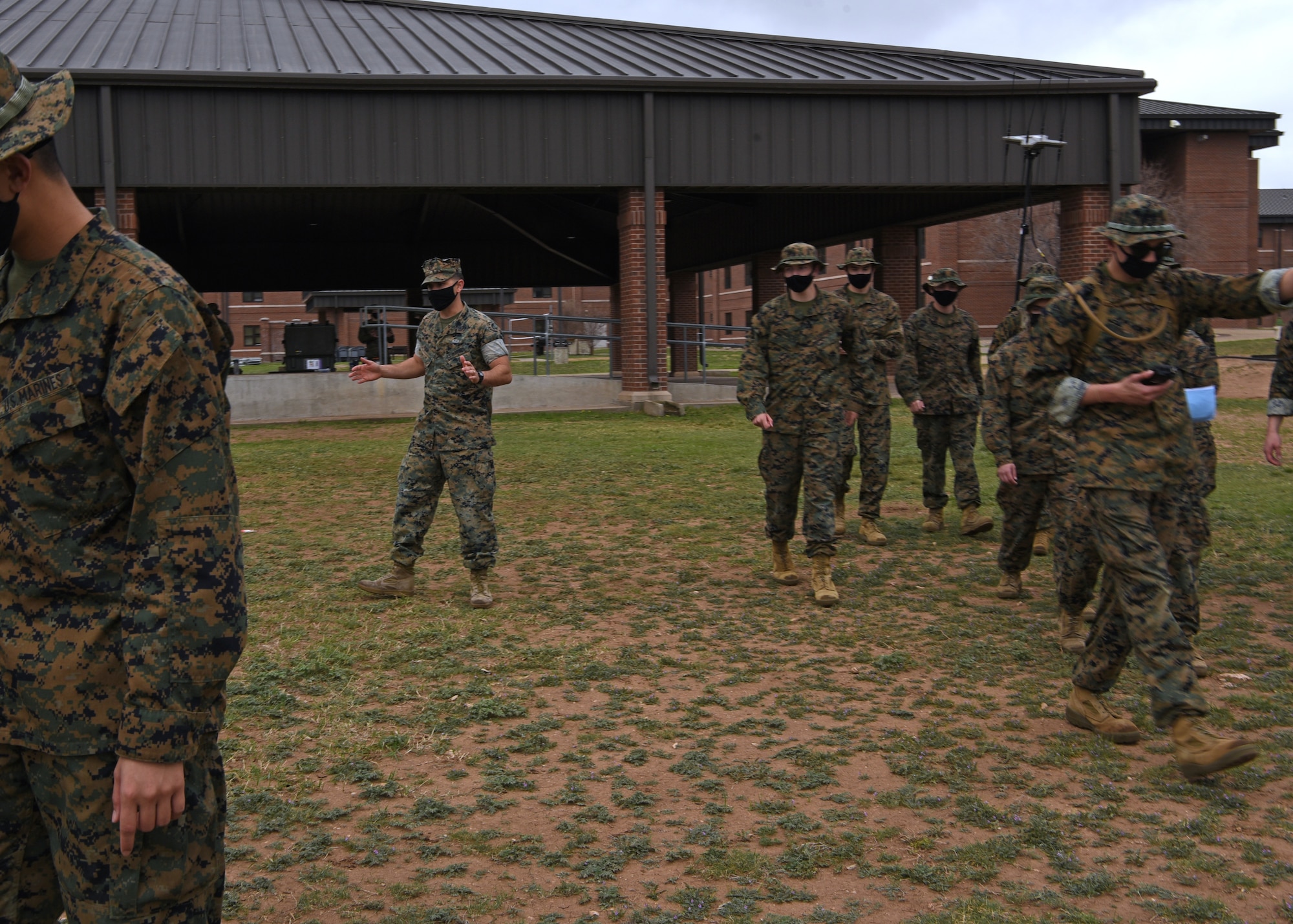 U.S. Marine Corps Gunnery Sgt. Zachary Fulk, Marine Corps Detachment Tactical Signals Intelligence Operator course instructor, sends his students off with words of encouragement to undertake an intelligence field exercise outside of the MCD dormitories on Goodfellow Air Force Base, Texas, March 22, 2021. The TSOC course trained universal intelligence skills to approximately 30 students, from 4 different job fields over a 12-training-day course. (U.S. Air Force photo by Senior Airman Abbey Rieves)