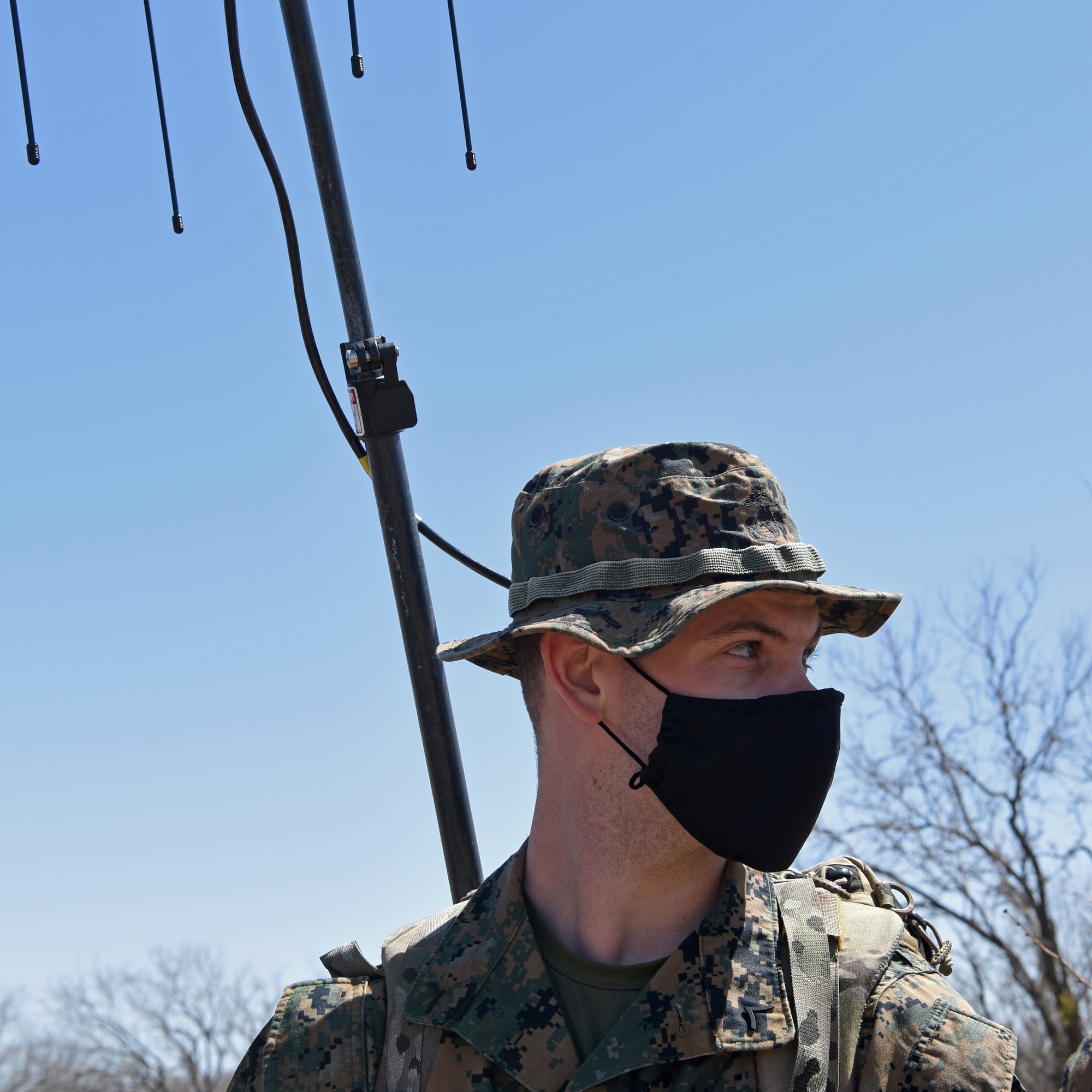U.S. Marine Corps Pfc. Logan Swanson, Marine Corps Detachment Tactical Signals Intelligence Operator course student, wears a versatile radio observation and direction finder in his backpack while navigating through an intelligence field exercise outside of the MCD dormitories on Goodfellow Air Force Base, Texas, March 23, 2021. When a signal is intercepted, the VROD’s antennas pinpointed which direction the pursued target was located. (U.S. Air Force photo by Senior Airman Abbey Rieves)