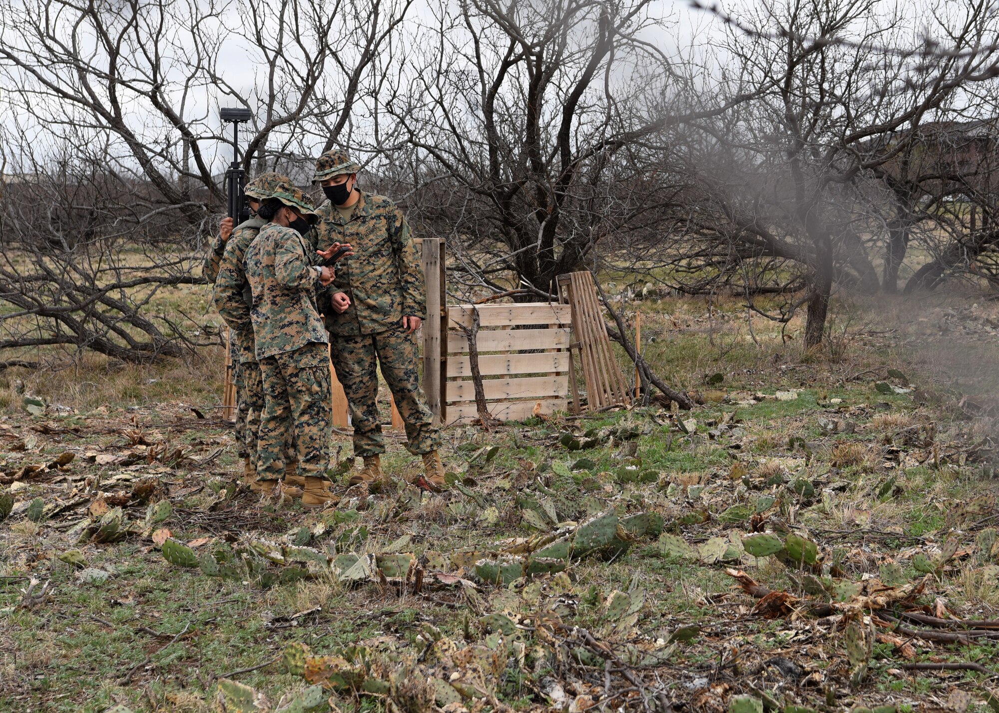 U.S. Marine Corps Tactical Signals Intelligence Operator course students from the Marine Corps Detachment, collaborate in teams to intercept a mock enemy intelligence signal with their THiEF, an intelligence signal collecting antenna, in a field exercise outside of the MCD dormitories on Goodfellow Air Force Base, Texas, March 22, 2021. The intelligence device was carried in a backpack by a student and was used to accelerate and fully integrate core training objectives. (U.S. Air Force photo by Senior Airman Abbey Rieves)