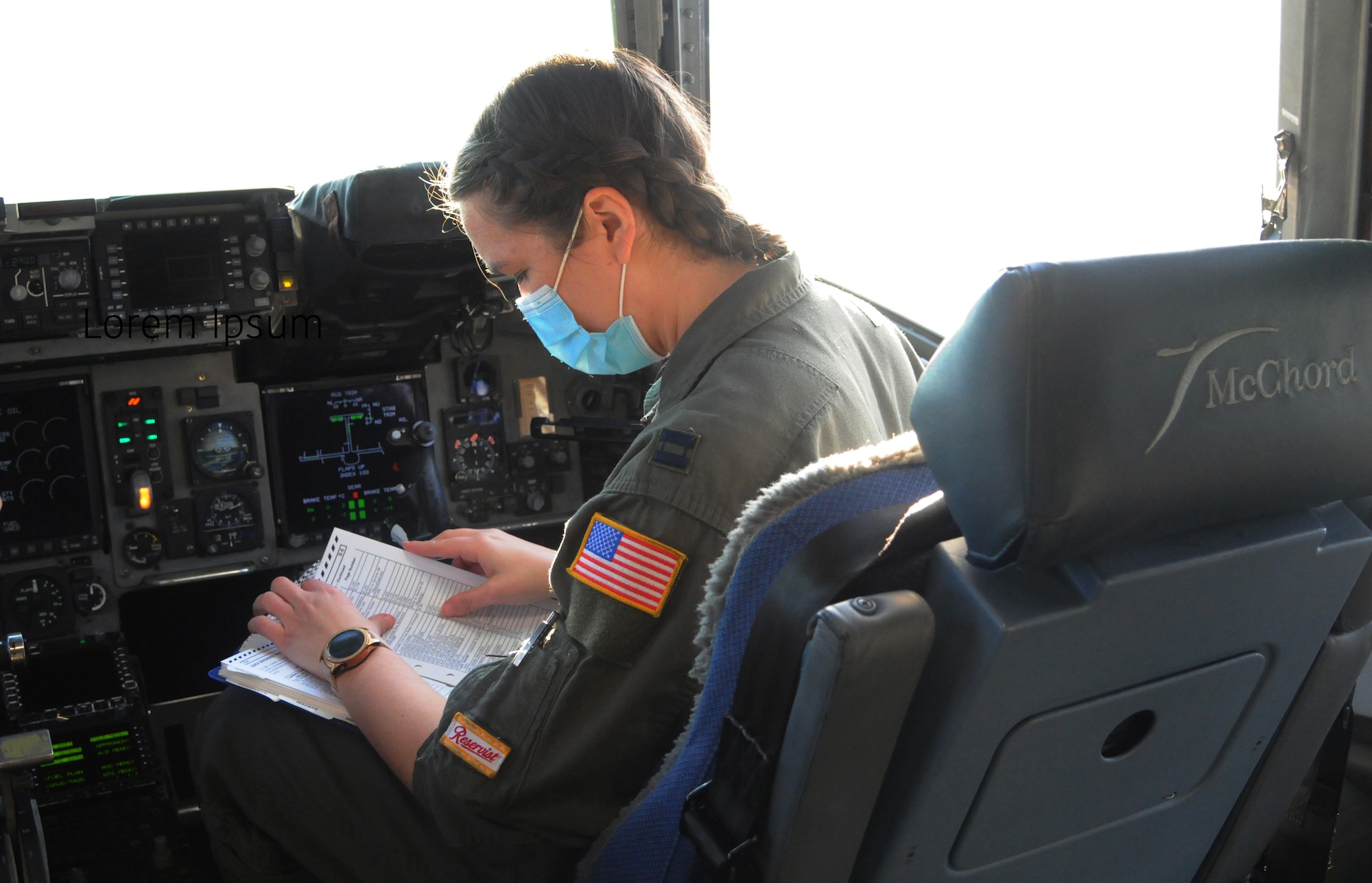 Capt. Rachel Sallee, a pilot assigned to the 728th Airlift Squadron, performs pre-flight checks before takeoff in a C-17 Globemaster III March 11 at McChord Field, Washington.