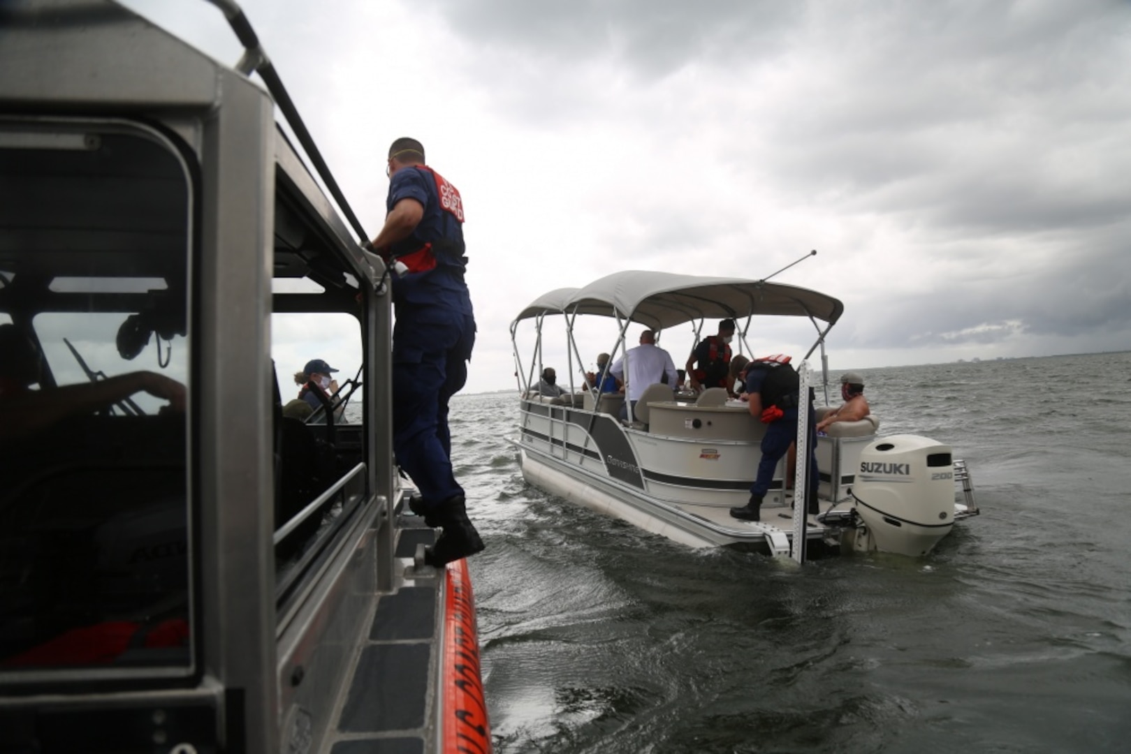 A Coast Guard Station St. Petersburg 29-foot Response Boat – Small II boat crew approaches the 27-foot boat Aug. 31, 2020, to conduct a safety boarding. Federal law requires uninspected passenger vessels to carry only a maximum of six passengers for hire with a Merchant Mariner Credential. Bareboat charters, when properly applied, transfer complete ownership of a vessel to the charterer as a recreational vessel. (U.S. Coast Guard photo by Petty Officer 3rd Class Erik Villa Rodriguez)