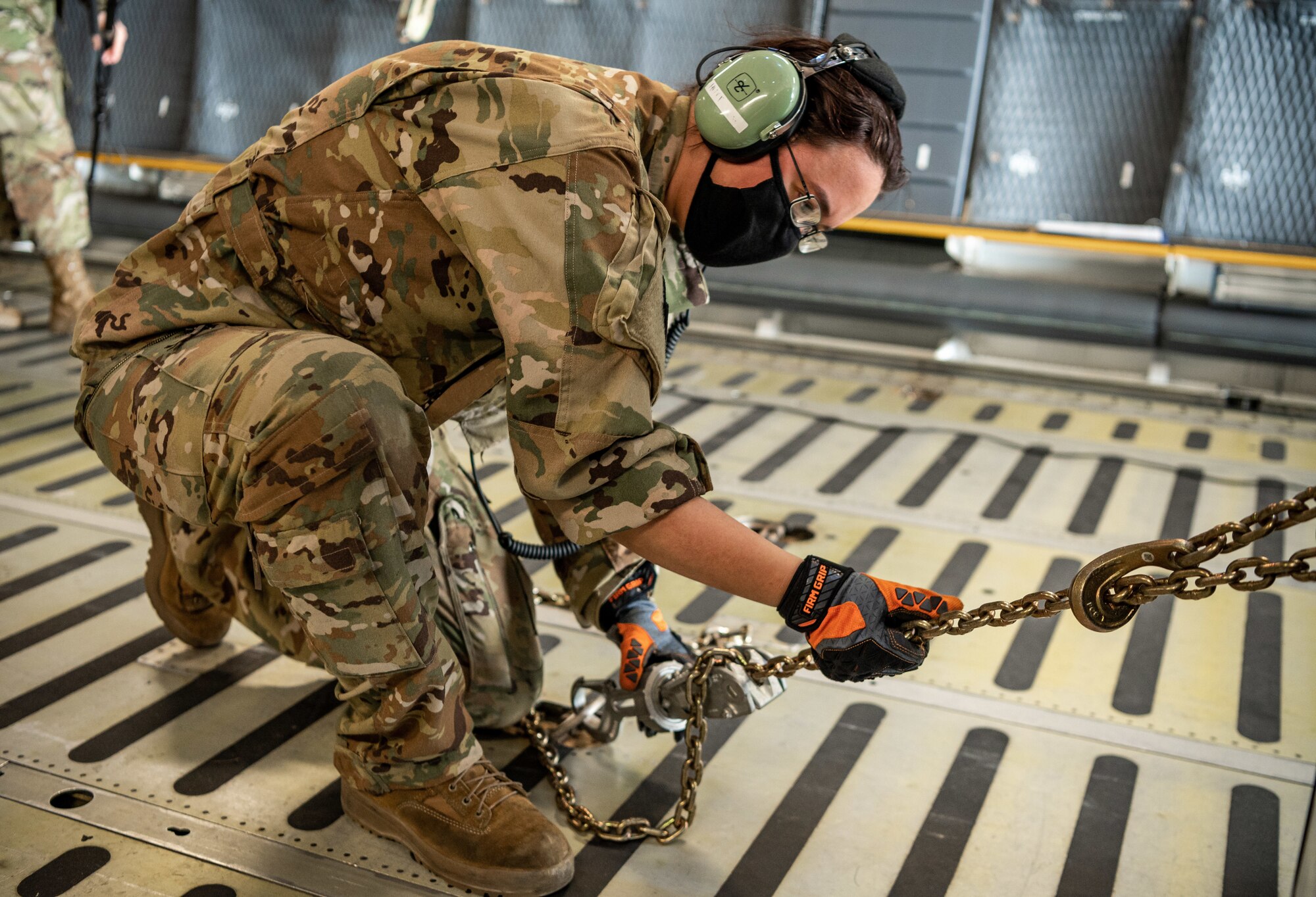 Senior Airman Rachael Hutt, 9th Airlift Squadron loadmaster, ties down a stake-bed truck onto a C-5M Super Galaxy during loadmaster training at Dover Air Force Base, Delaware, March 9, 2021. Loadmasters from the 9th Airlift Squadron participated in the training as part of a Major Command Service Tail Trainer initiative driven by Air Mobility Command. The training expedites C-5 loadmaster upgrade training, enabling Dover AFB to provide rapid global airlift.  (U.S. Air Force photo by Senior Airman Christopher Quail)