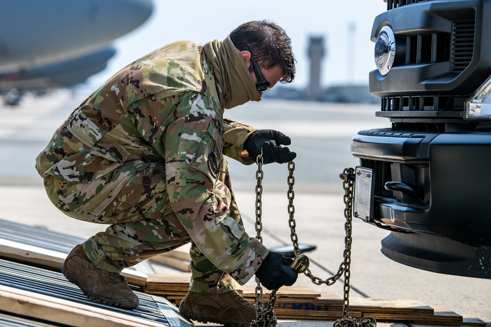 Airman 1st Class Jordan Gibson, 9th Airlift Squadron loadmaster, prepares a stake-bed truck for loading onto a C-5M Super Galaxy during loadmaster training at Dover Air Force Base, Delaware, March 9, 2021.  Loadmasters from the 9th Airlift Squadron participated in the training as part of a Major Command Service Tail Trainer initiative driven by Air Mobility Command. The training expedites C-5 loadmaster upgrade training, enabling Dover AFB to provide rapid global airlift.  (U.S. Air Force photo by Senior Airman Christopher Quail)