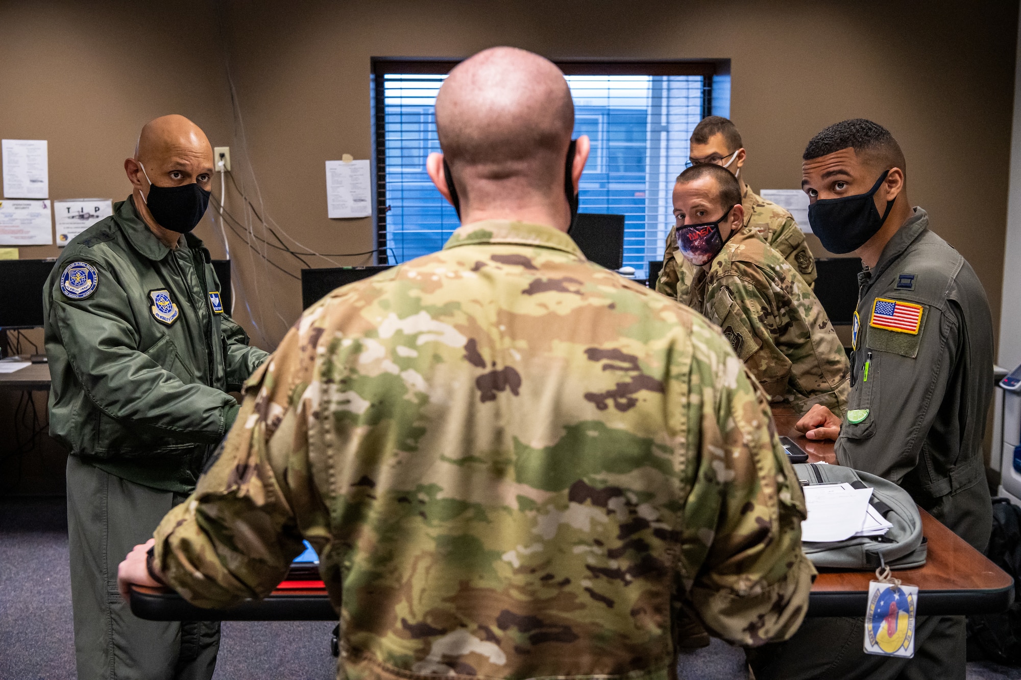 U.S. Air Force Lt. Gen. Brian Robinson, Air Mobility Command deputy commander, left, and 3rd Airlift Squadron aircrew members, receive a preflight briefing at Dover Air Force Base, Delaware, March 23, 2021. Robinson visited Dover AFB to engage with base leaders and fulfill training requirements on the C-17 Globemaster III. (U.S. Air Force photo by Senior Airman Christopher Quail)