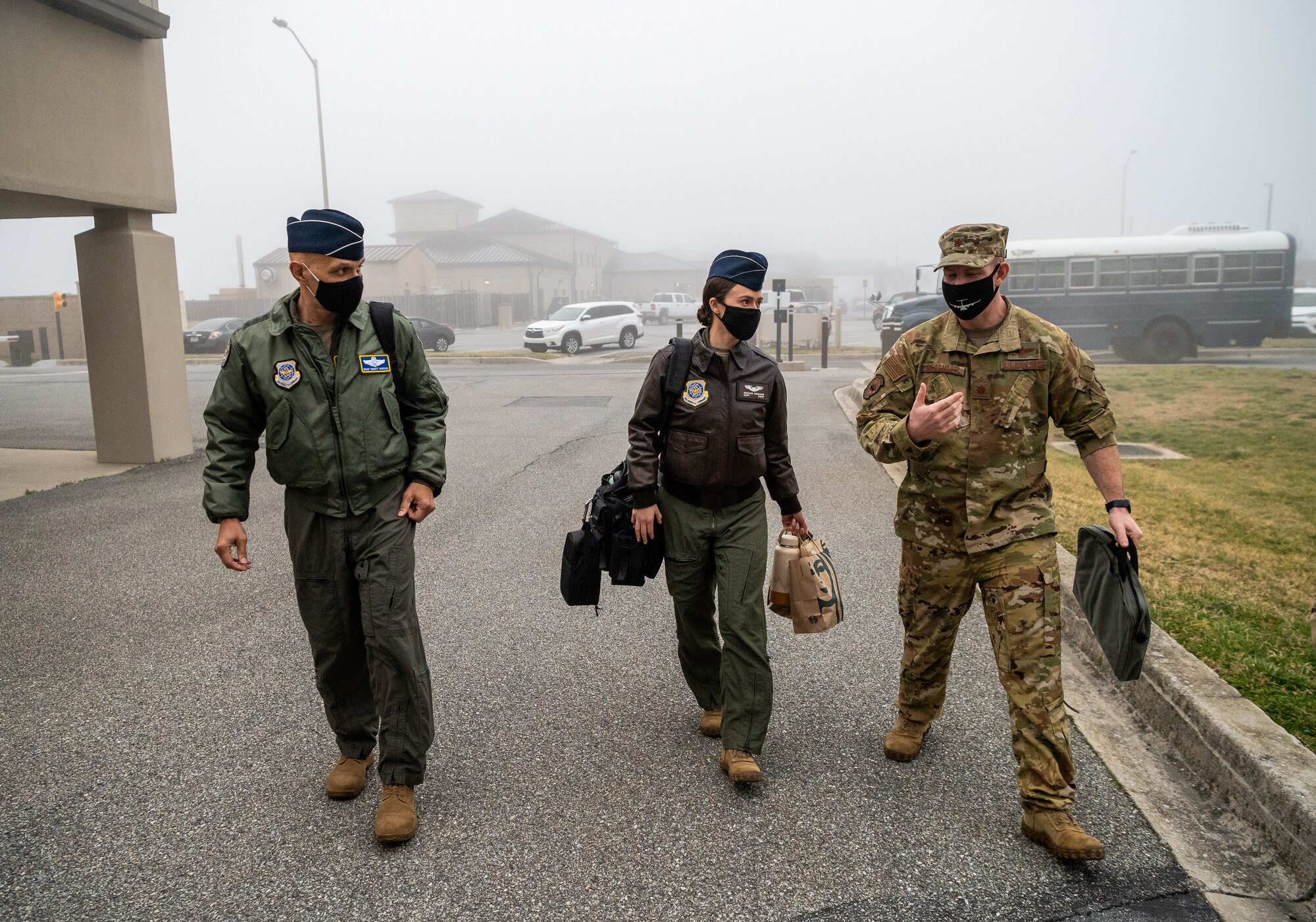 From left, U.S. Air Force Airmen Lt. Gen. Brian Robinson, Air Mobility Command deputy commander, Capt. Kaitlyn Tinkham, AMC executive officer to the deputy commander, and Maj. Steven Beachler, 3rd Airlift Squadron pilot, walk to the base operations building prior to a flight at Dover Air Force Base, Delaware, March 23, 2021. Robinson visited Dover AFB to engage with base leaders and fulfill training requirements on the C-17 Globemaster III. (U.S. Air Force photo by Senior Airman Christopher Quail)