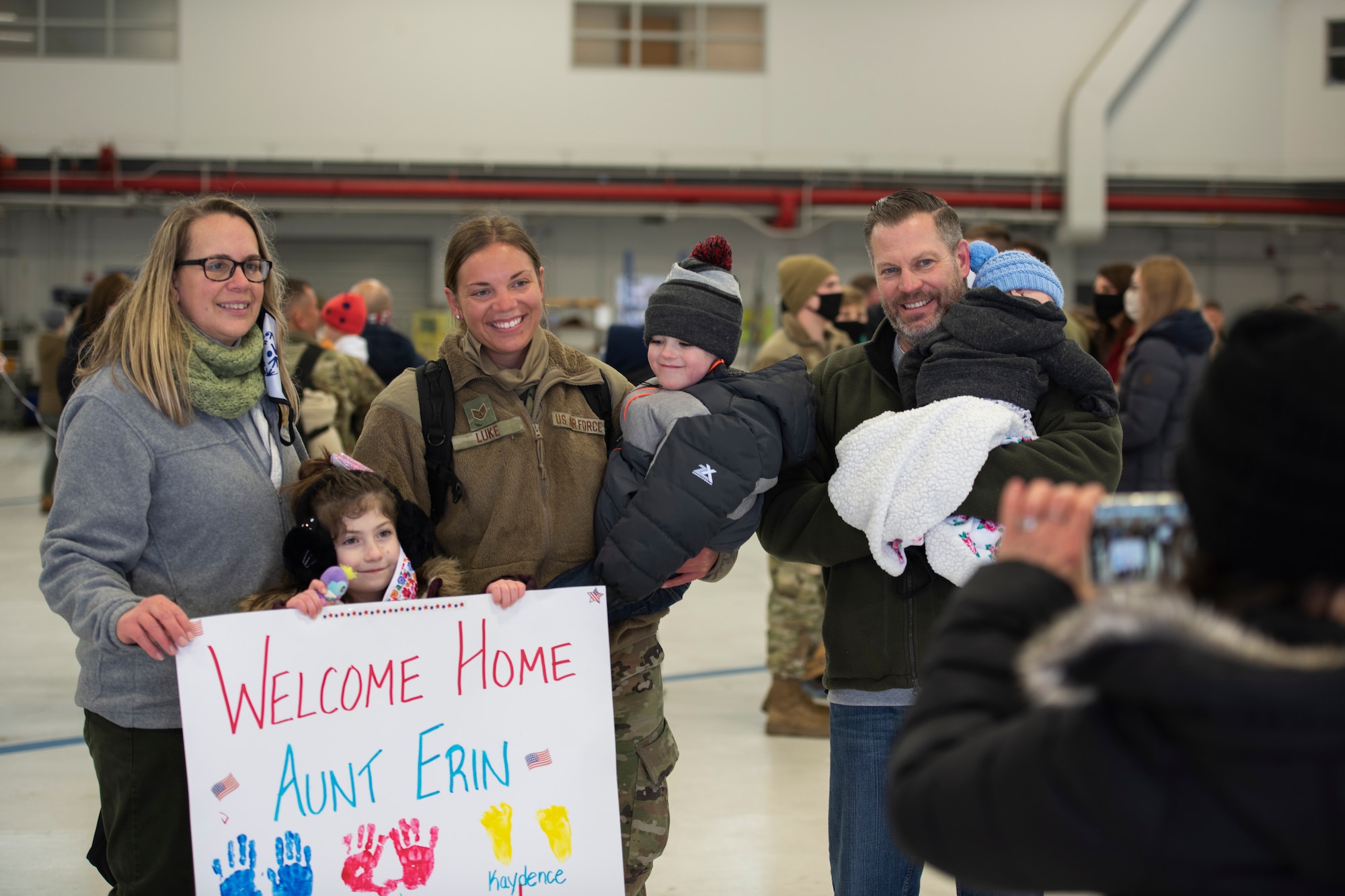 Staff Sgt. Erin Luke, a weapons technician, assigned to the Ohio National Guard’s 180th Fighter Wing, poses for a photo with family members after being welcomed home from their overseas deployment, Jan. 26, 2020 at the 180FW in Swanton, Ohio.