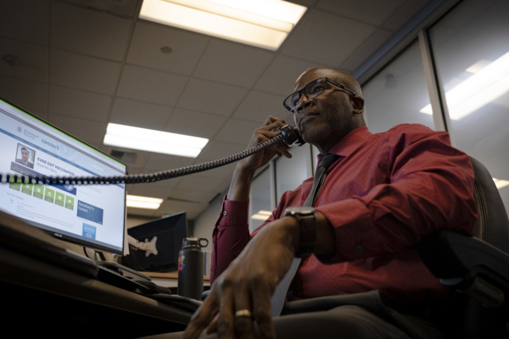 Joseph Ford, a Coast Guard Sector San Francisco command duty officer, answers the phone at Sector San Francisco command center, March 4, 2021. Ford and Travis Addison, a Sector San Francisco civilian search-and-rescue controller, coordinated the rescue of a young woman who entered the water with no flotation device on January 31, 2021. (U. S. Coast Guard photo by Petty Officer 2nd Class Brandon Giles)