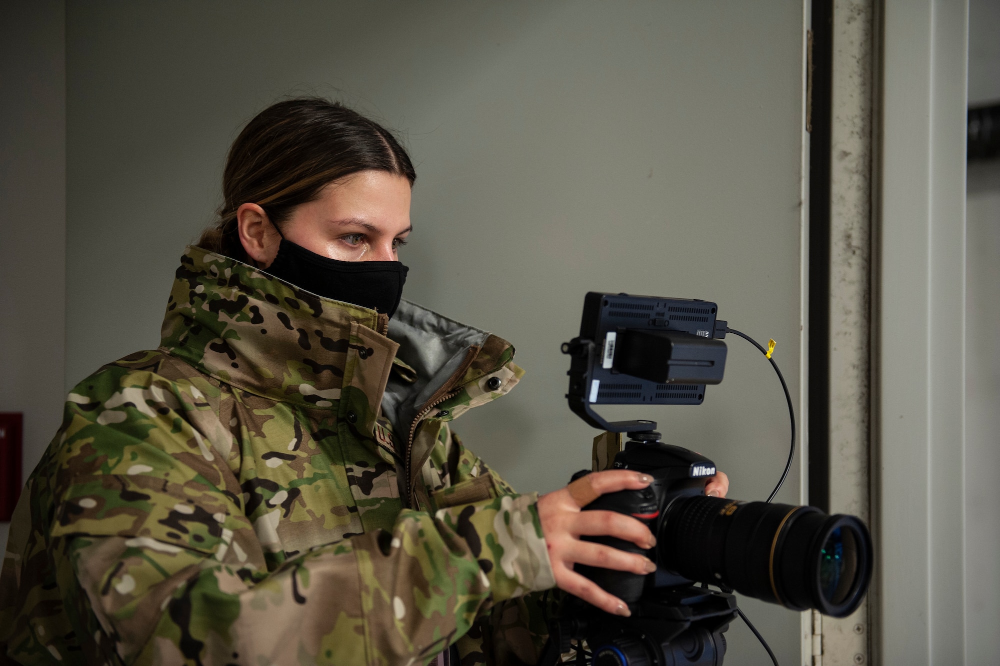 U.S. Air Force Staff Sgt. Hope Geiger, a photojournalist assigned to the Ohio National Guard’s 180th Fighter Wing, captures video footage of 180FW maintenance personnel preparing aircraft for morning training sorties in the frigid, 5° degree temperatures, Feb. 7, 2021.