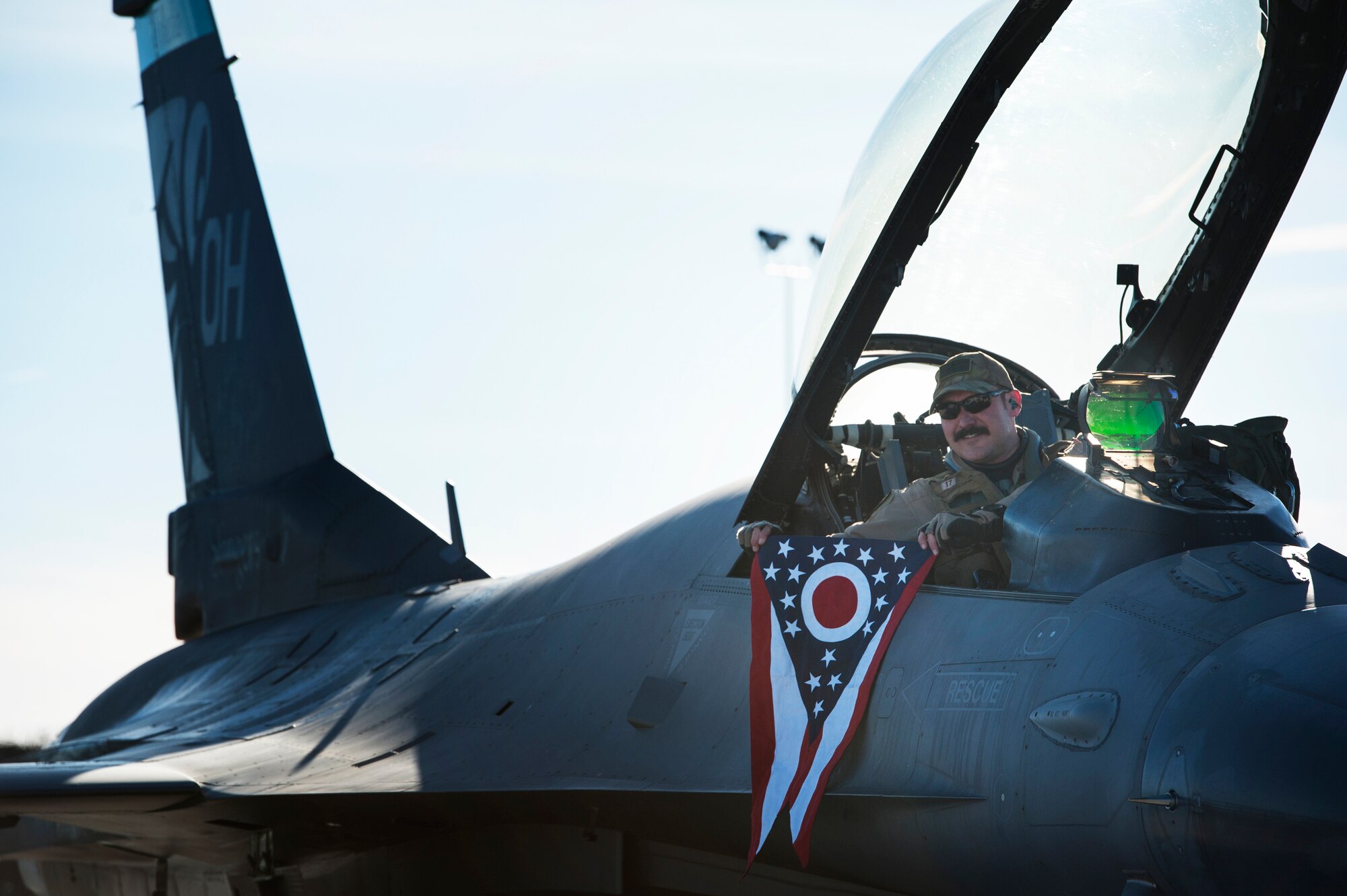 U.S. Air Force F-16 Fighting Falcon pilot, Lt. Col. Curt Voltz, assigned to the Ohio National Guard’s 180th Fighter Wing, proudly displays the state of Ohio flag after landing on Ohio soil for the first time after returning home from a three-month Aerospace Expeditionary Force deployment to Bagram Air Base, Afghanistan, Jan. 23, 2021.