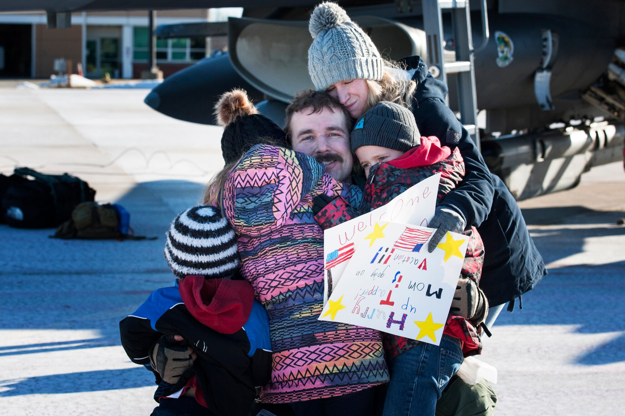 U.S. Air Force F-16 Fighting Falcon pilot, Maj. Tapper Moore, assigned to the Ohio National Guard’s 180th Fighter Wing, greets his family for the first time after returning home from a three-month Aerospace Expeditionary Force deployment to Bagram Air Base, Afghanistan, Jan. 23, 2021.