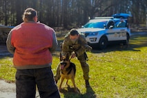 Staff Sgt. Joseph Schembri, a military working dog handler assigned to the 628th Security Forces Squadron, holds on to MWD, Kantor, as he prepares to practice bite work with Senior Airmen Shannon McCarter, also a MWD handler assigned to the 628th SFS, March 10, 2021 on Joint Base Charleston S.C. Military working dogs are used in the military for detecting explosives, searching for contraband and drugs and patrolling. They advance their training on a daily basis and also hone in their skill that they have already learned.