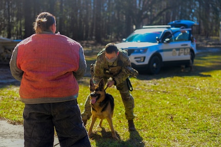 Staff Sgt. Joseph Schembri, a military working dog handler assigned to the 628th Security Forces Squadron, holds on to MWD, Kantor, as he prepares to practice bite work with Senior Airmen Shannon McCarter, also a MWD handler assigned to the 628th SFS, March 10, 2021 on Joint Base Charleston S.C. Military working dogs are used in the military for detecting explosives, searching for contraband and drugs and patrolling. They advance their training on a daily basis and also hone in their skill that they have already learned.