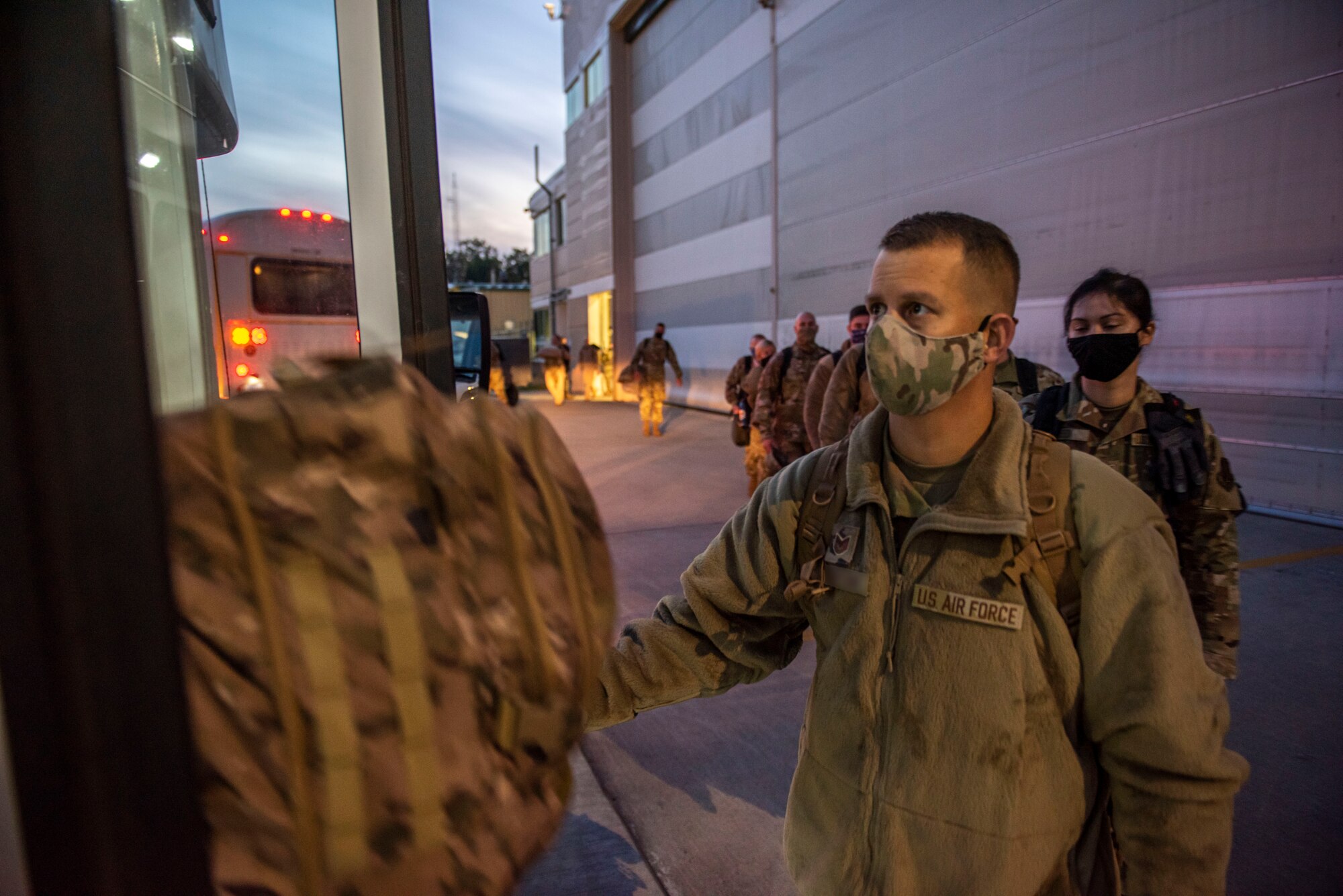 U.S. Airmen, assigned to the Ohio National Guard’s 180th Fighter Wing, board a bus at the 180FW in Swanton, Ohio, Oct. 3, 2020.