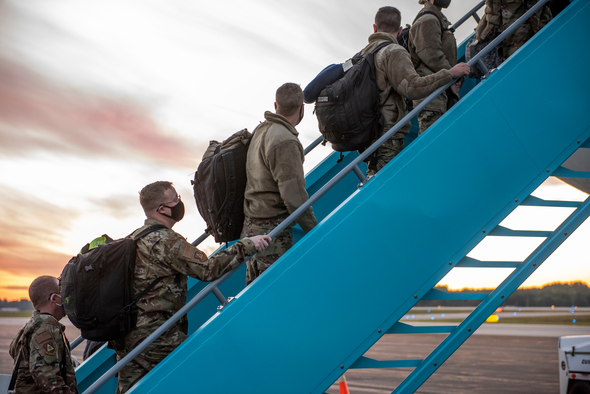 U.S. Airmen, assigned to the Ohio National Guard’s 180th Fighter Wing, board a plane at the Toledo Express Airport, Oct. 3, 2020.