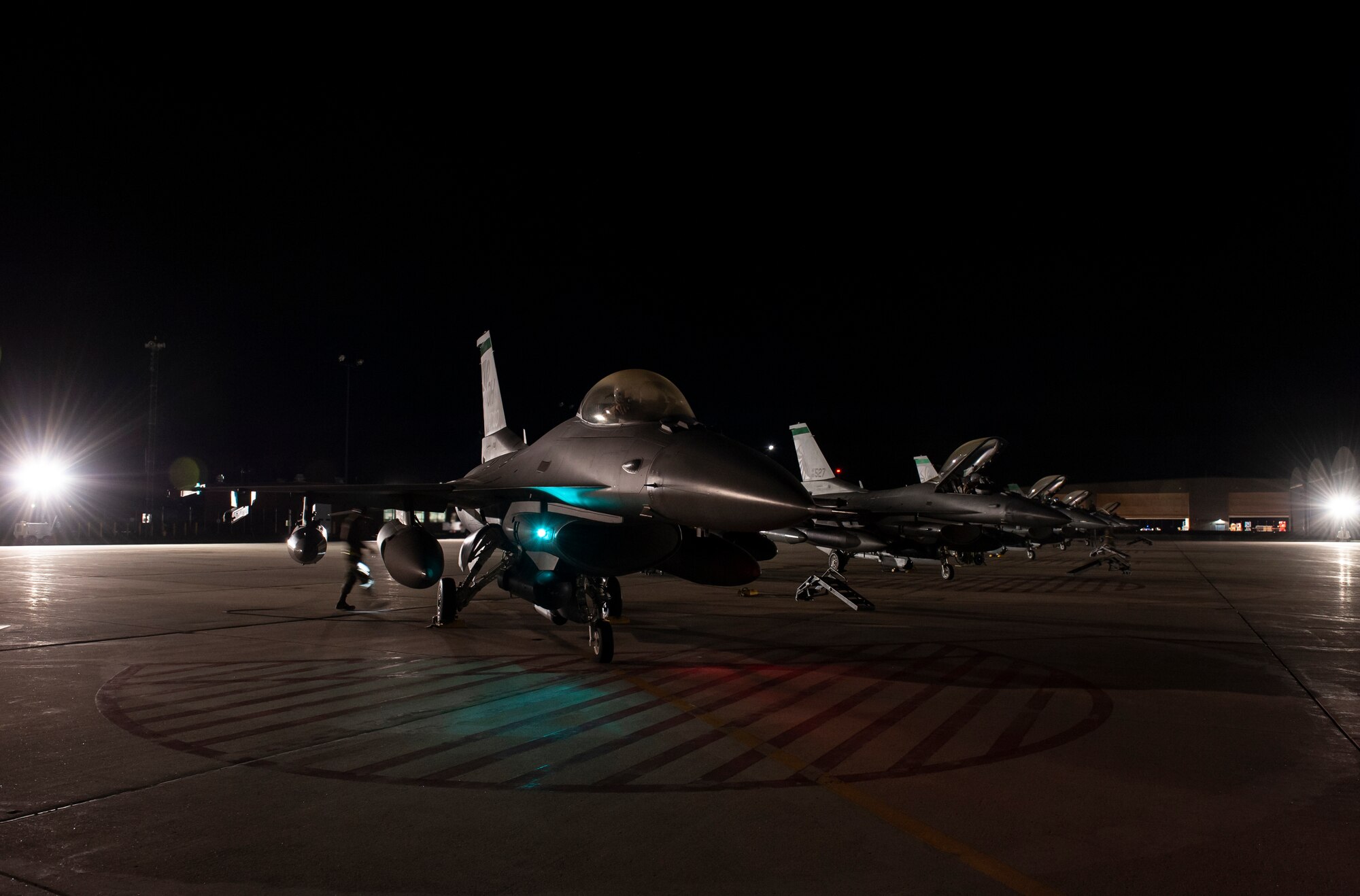 F-16 Fighting Falcon fighter jets, assigned to the Ohio National Guard’s 180th Fighter Wing, sit ready on the flightline in the early morning hours, O.t. 12, 2020, before departing from the 180FW, in Swanton, Ohio, for an Aerospace Expeditionary Force deployment.
