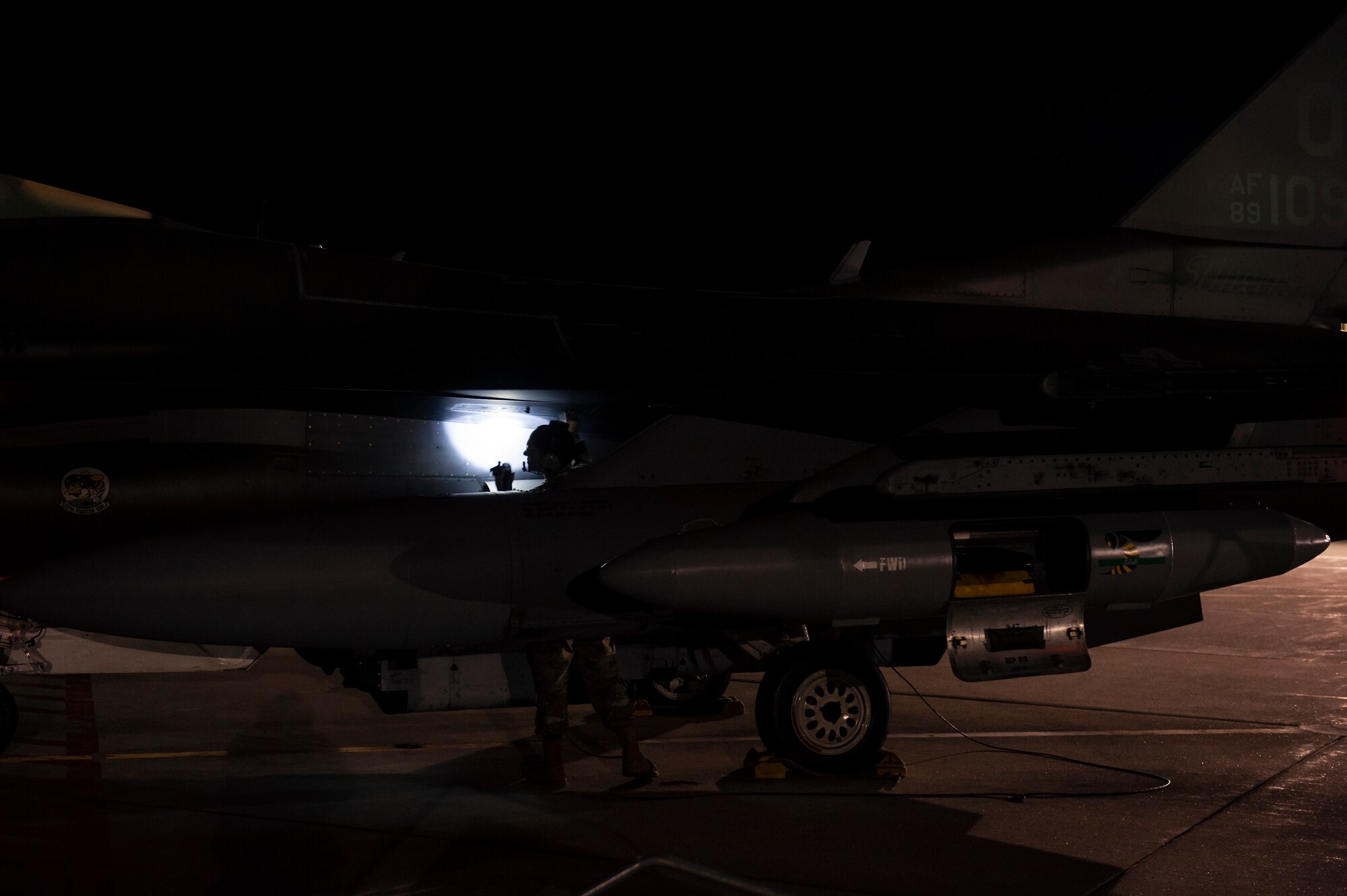 A U.S. Air Force Airman, assigned to the Ohio National Guard’s 180th Fighter Wing, executes preflight procedures on an F-16 Fighting Falcon prior to an early morning launch, Oct. 12, 2020, as the fighter jets depart from the 180FW in Swanton, Ohio, for an Aerospace Expeditionary Force deployment.