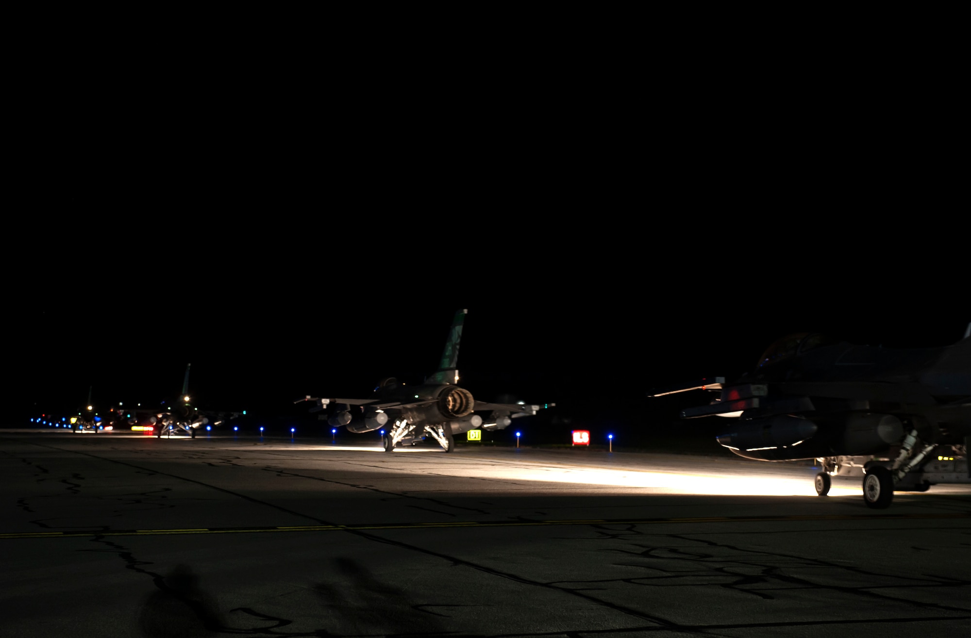F-16 Fighting Falcon fighter jets, assigned to the Ohio National Guard’s 180th Fighter Wing, prepare to takeoff in the early morning hours, O.t. 12, 2020, before departing from the 180FW, in Swanton, Ohio, for an Aerospace Expeditionary Force deployment.