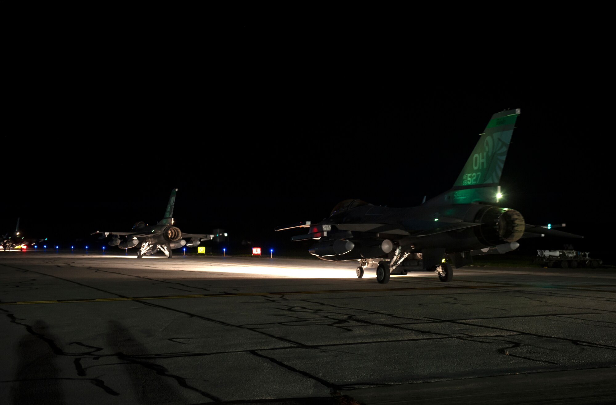F-16 Fighting Falcon fighter jets, assigned to the Ohio National Guard’s 180th Fighter Wing, prepare to takeoff in the early morning hours, O.t. 12, 2020, before departing from the 180FW, in Swanton, Ohio, for an Aerospace Expeditionary Force deployment.