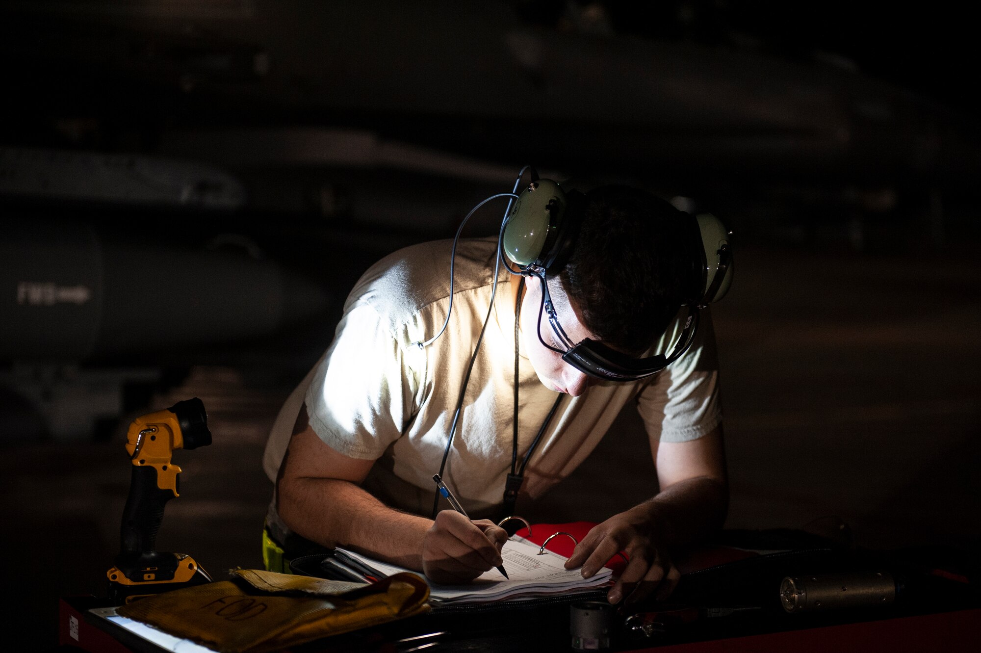 A U.S. Air Force Airman, assigned to the Ohio National Guard’s 180th Fighter Wing, reviews aircraft forms prior to an early morning launch, Oct. 12, 2020, as they depart from the 180FW in Swanton, Ohio, for an Aerospace Expeditionary Force deployment.