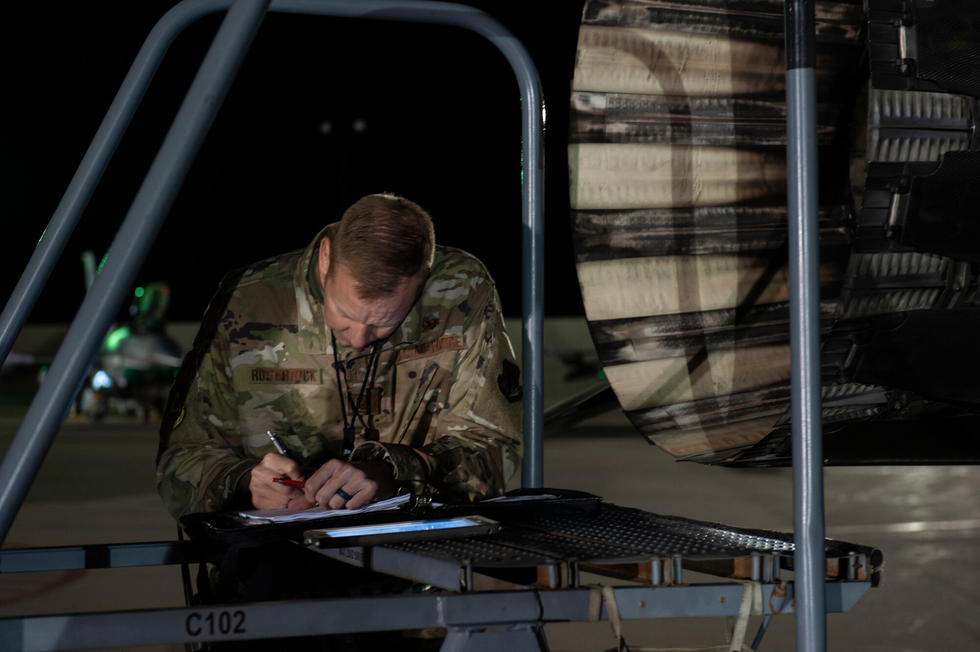 A U.S. Air Force Airman, assigned to the Ohio National Guard’s 180th Fighter Wing, reviews aircraft forms prior to an early morning launch, Oct. 12, 2020, as they depart from the 180FW in Swanton, Ohio, for an Aerospace Expeditionary Force deployment.
