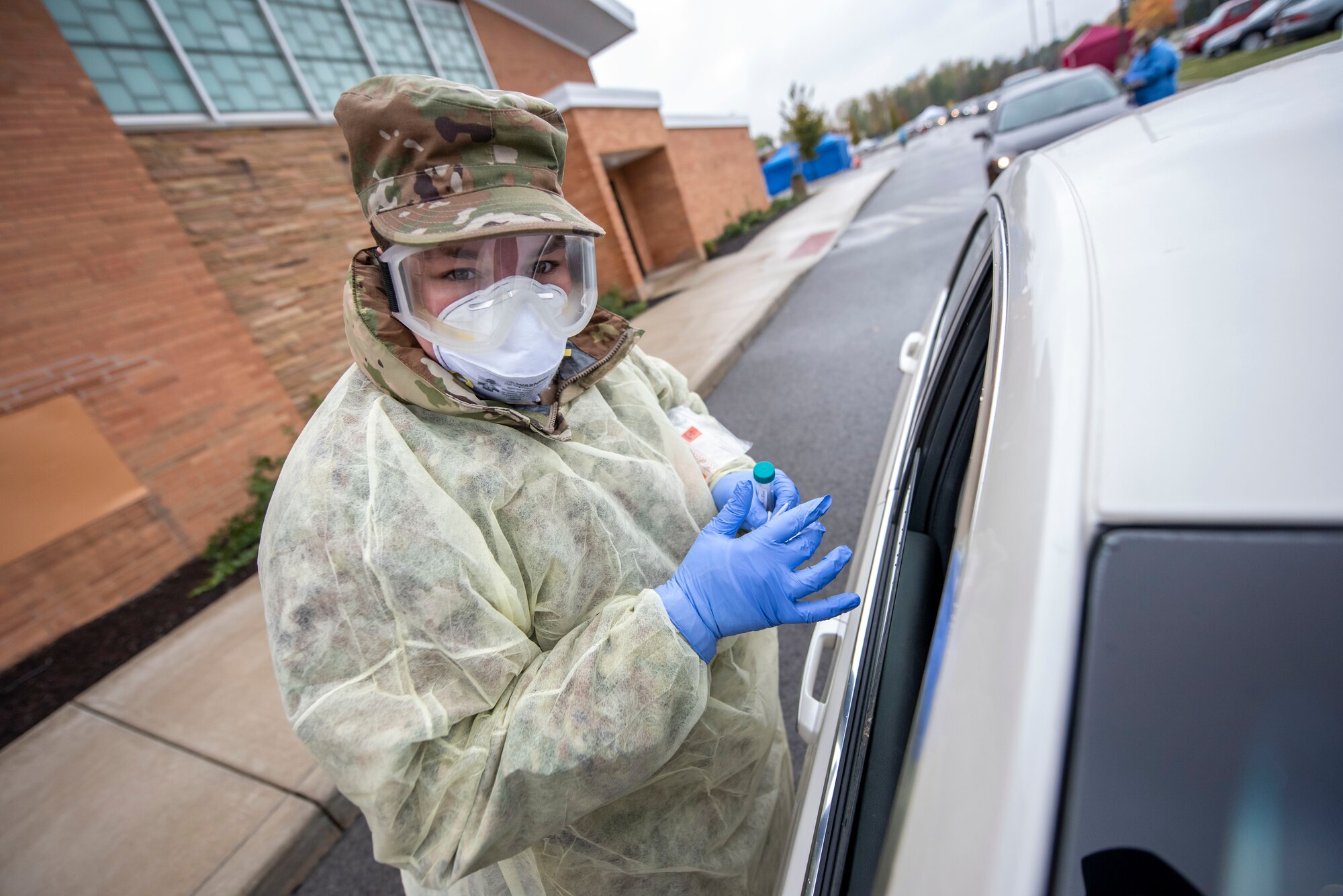 Cpl. Nikki Sherman, a Soldier assigned to the Ohio Military Reserve, performs a COVID-19 test during a pop-up testing drive-thru at Anthony Wayne Junior High School in Whitehouse, Ohio, Oct. 19, 2020.