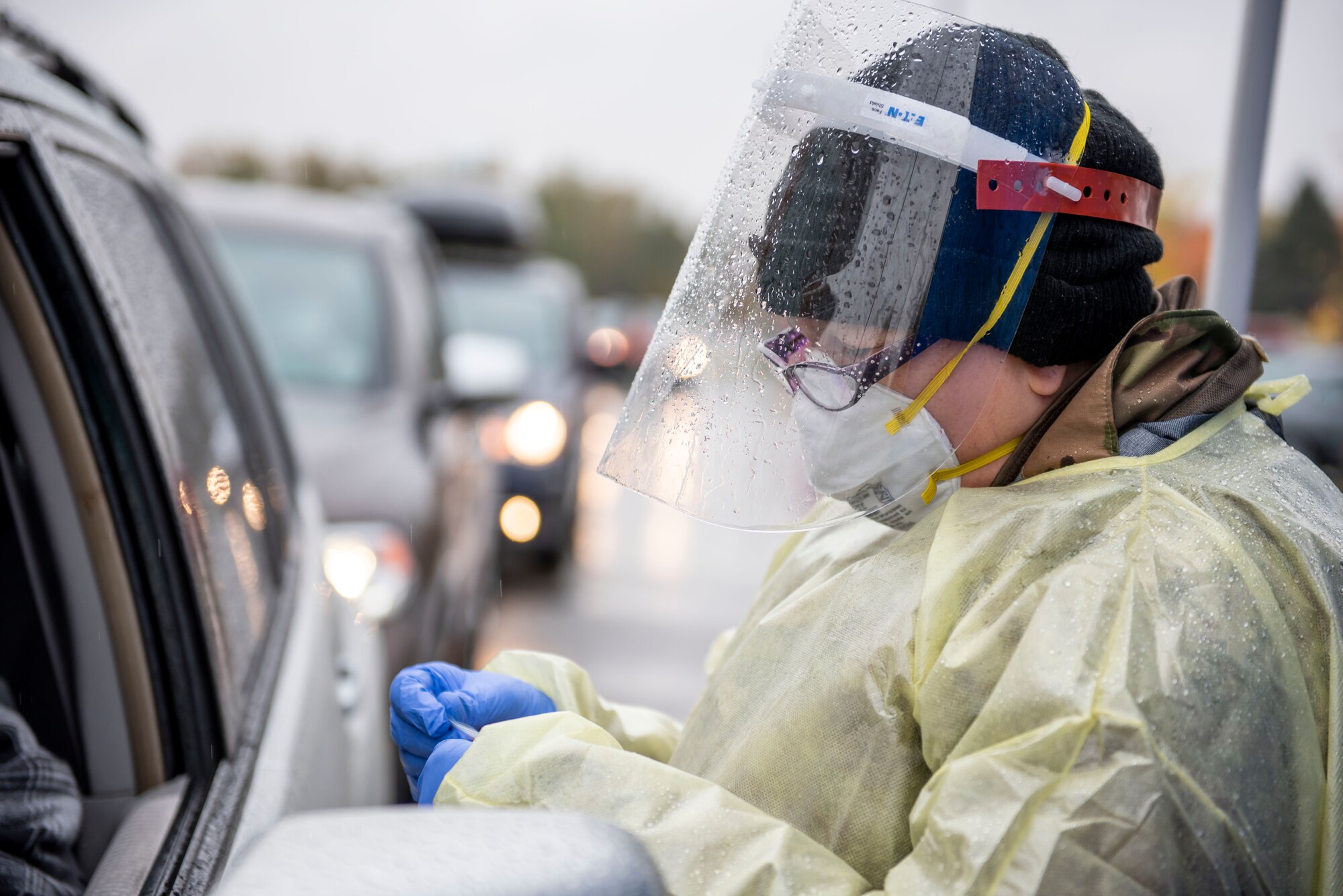 Pfc. Lisa Meabon, a Soldier assigned to the Ohio Military Reserve, conducts a COVID-19 test during a pop-up testing drive-thru at Anthony Wayne Junior High School in Whitehouse, Ohio, Oct. 19, 2020.