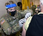 Staff Sgt. Rachel Hammill from the U.S. Army Institute of Surgical Research at Joint Base San Antonio-Fort Sam Houston prepares to administer a COVID-19 vaccine at the JBSA-Fort Sam Houston vaccination site.