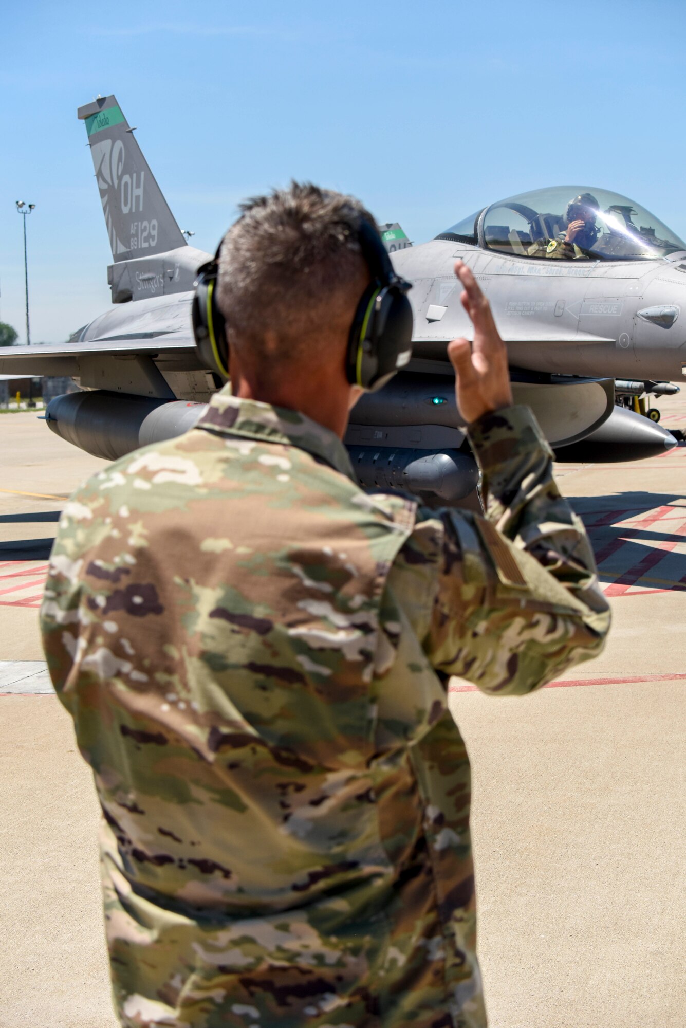 U.S. Air Force Master Sgt. Terry Copic, a crew chief assigned to the 113th Wing, D.C. Air National Guard, launches an F-16 Fighting Falcon, assigned to the Ohio National Guard’s 180th Fighter Wing, piloted by his nephew, 1st Lt. T.J. Copic, an F-16 fighter pilot assigned to the 180FW, for a training flight at the 180FW in Swanton, Ohio, June 30, 2020.