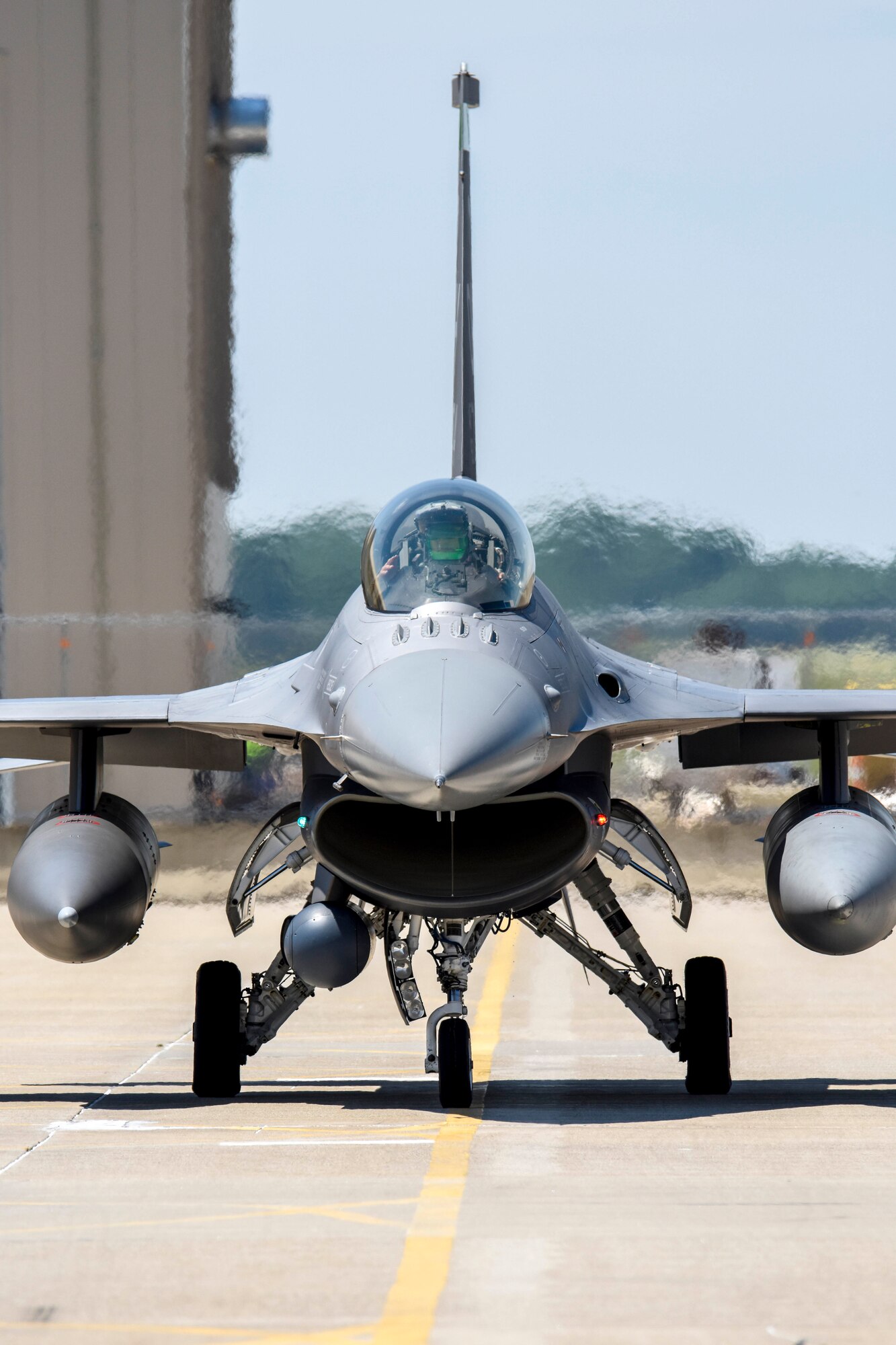 An F-16 fighter pilot, assigned to the Ohio National Guard’s 180th Fighter Wing, taxis an F-16 Fighting Falcon across the flightline for a training flight at the 180FW in Swanton, Ohio, June 30, 2020.