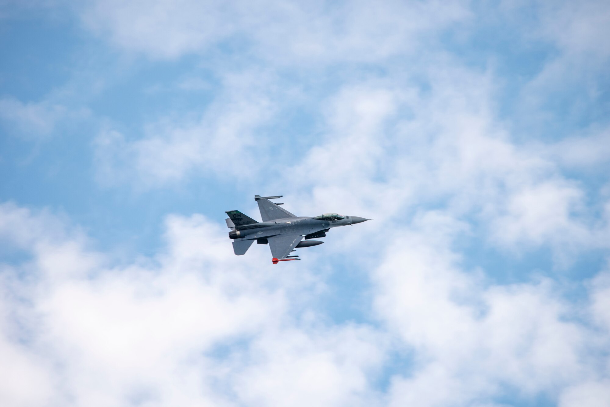 A U.S. Air Force F-16 Fighting Falcon, assigned to the Ohio National Guard’s 180th Fighter Wing, flies over the 180FW during a training flight in Swanton, Ohio, Aug. 6, 2020.