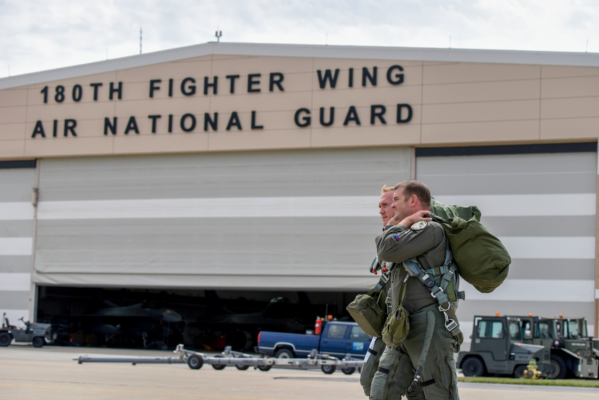 U.S. Air Force F-16 Fighter Pilots, assigned to the Ohio National Guard’s 180th Fighter Wing, walk across the flightline before a training flight at the 180FW in Swanton, Ohio, July 30, 2020.