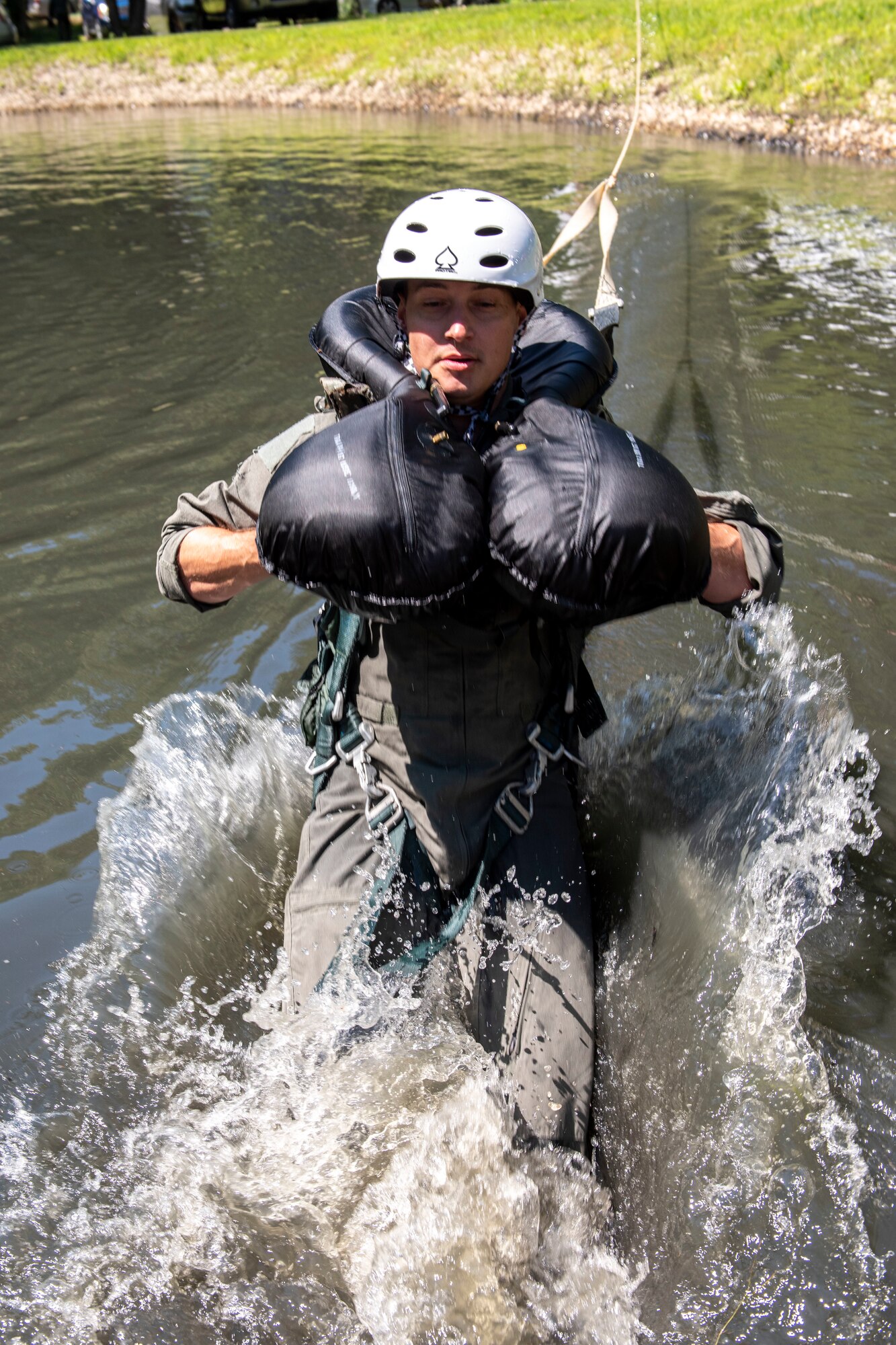 U.S. Air Force Capt. Jared Schulz, an F-16 fighter pilot assigned to the Ohio National Guard's 180th Fighter Wing, is dragged through the water during water survival training in Waterville, Ohio, Aug. 8, 2020.