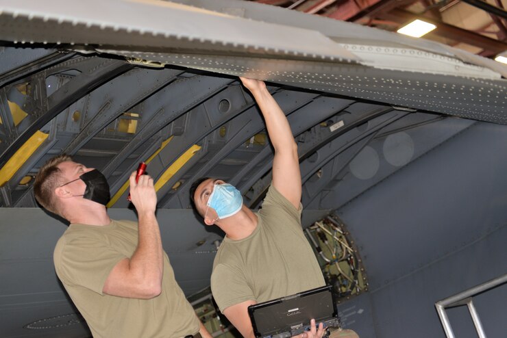 Two Airmen inspecting an aircraft