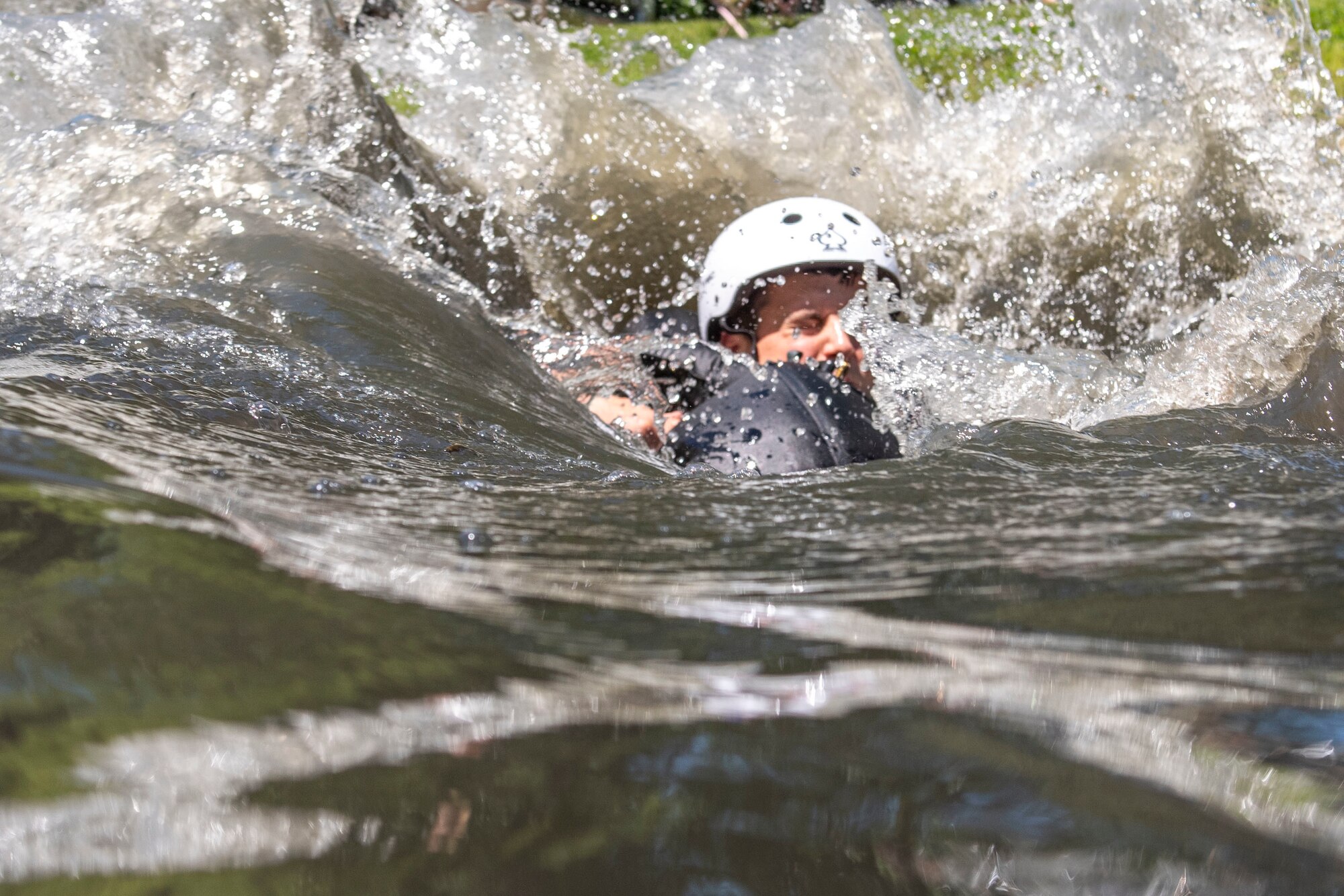 A U.S. Air Force F-16 fighter pilot, assigned to the Ohio National Guard's 180th Fighter Wing, is dragged through the water during water survival training in Waterville, Ohio, Aug. 8, 2020.