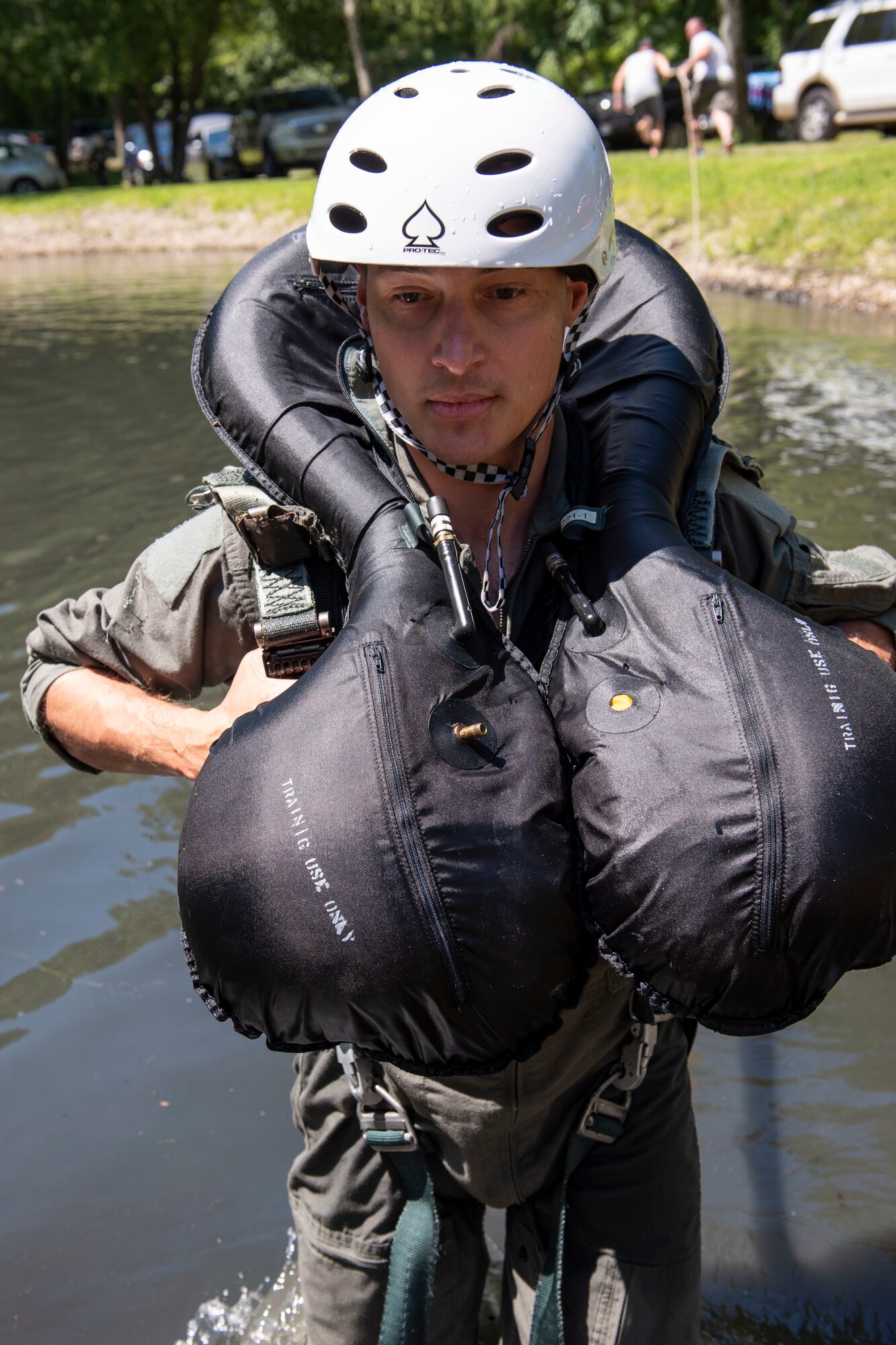 U.S. Air Force Capt. Jared Schulz, an F-16 fighter pilot assigned to the Ohio National Guard's 180th Fighter Wing, prepares to be dragged through the water during water survival training in Waterville, Ohio, Aug. 8, 2020.