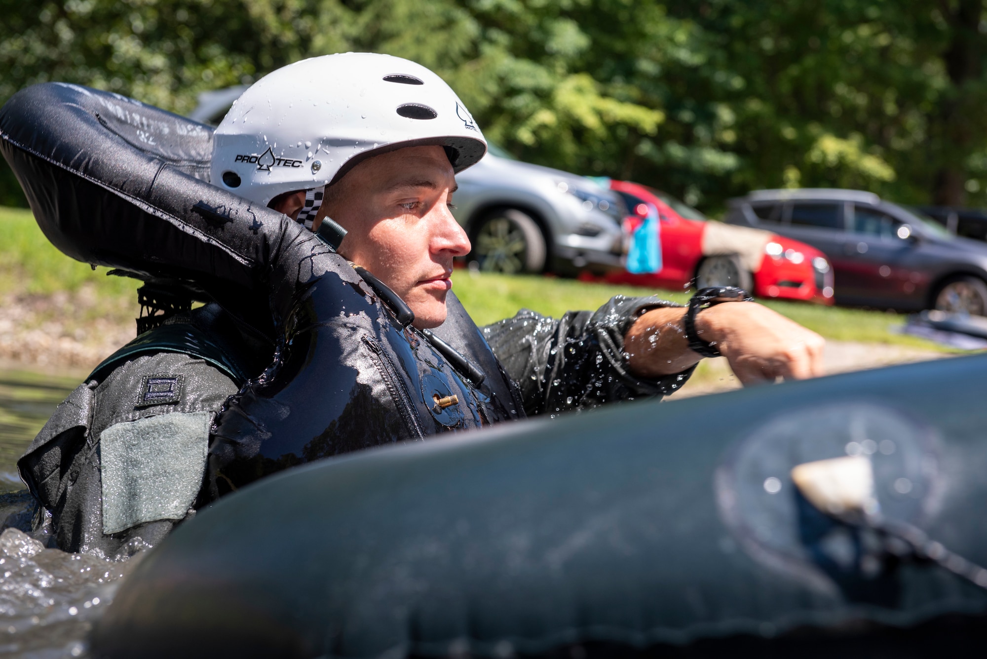 U.S. Air Force Capt. Jared Schulz, an F-16 fighter pilot assigned to the Ohio National Guard's 180th Fighter Wing, is dragged through the water during water survival training in Waterville, Ohio, Aug. 8, 2020.